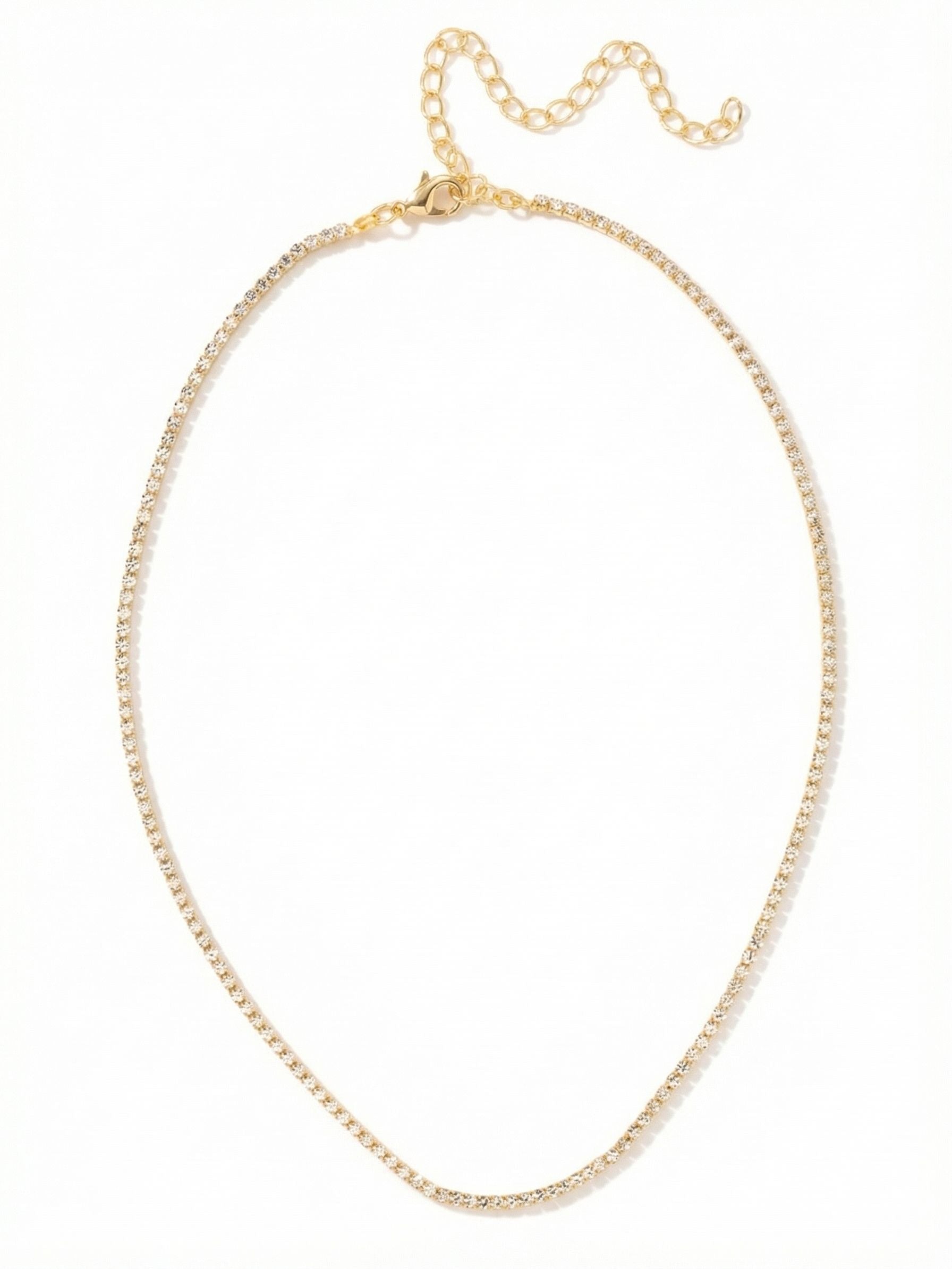 Mini Marnie Tennis Necklace - NFL2BGCRY - <p>A continuous thread of delicate crystal that follows the natural curve of the collarbone. Built from a fluid rhinestone chain, the slender profile of the Mini Marnie reads as an effortless foundation layer rather than a heavy statement. The bright gold-tone setting warms the clear crystals, catching ambient light with every turn of the head. An extension chain allows you to easily adjust the placement, letting you nestle this fine line exactly where your neckline demands.</p><ul>
<li>Ultra-fine rhinestone chain that drapes fluidly</li>
<li>Slender continuous line of crystals for minimalist layering</li>
<li>Lobster claw clasp</li>
<li>4-inch adjustable extension chain</li>
<li>Protective e-coat finish for lasting wear</li>
<li>Includes signature organza pouch for gifting and travel</li>
</ul>