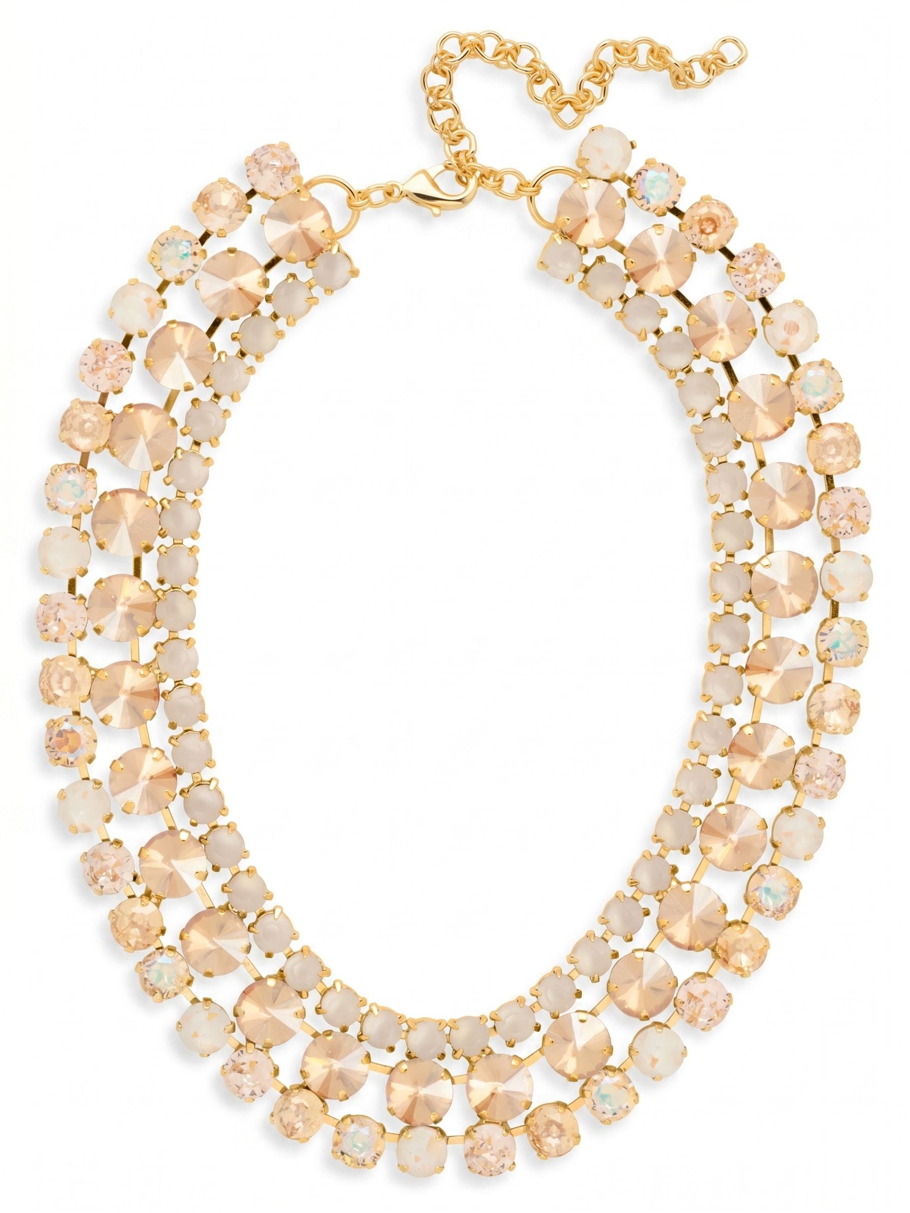 Sloane Layered Statement Necklace - NFL60BGGGO - <p>The Sloane Layered Statement Necklace rests at the collarbone as an intricate lattice of warm light. Over a hundred individual crystals in shades of golden shadow, vintage rose, and iridescent white are set into a fluid channel chain construction. This piece possesses a satisfying weight that settles securely around the neckline while adapting to your natural movement. The integrated extension chain provides a precise fit, allowing you to tailor the drape exactly where you want it. It brings a dense, concentrated brilliance that transforms even the simplest silk blouse.</p><ul>
<li>Fluid channel chain construction creates a flexible and layered silhouette</li>
<li>Dense arrangement of round crystals in a warm golden shadow and vintage rose palette</li>
<li>Lobster claw clasp</li>
<li>4-inch adjustable extension chain</li>
<li>Protective e-coat finish for lasting wear</li>
<li>Includes signature organza pouch for gifting and travel</li>
</ul>