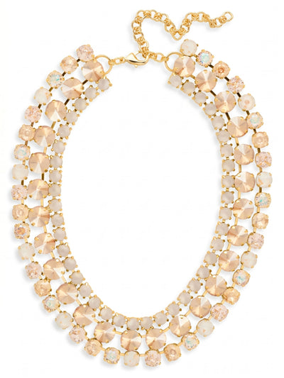 Sloane Layered Statement Necklace - NFL60BGGGO - <p>The Sloane Layered Statement Necklace rests at the collarbone as an intricate lattice of warm light. Over a hundred individual crystals in shades of golden shadow, vintage rose, and iridescent white are set into a fluid channel chain construction. This piece possesses a satisfying weight that settles securely around the neckline while adapting to your natural movement. The integrated extension chain provides a precise fit, allowing you to tailor the drape exactly where you want it. It brings a dense, concentrated brilliance that transforms even the simplest silk blouse.</p><ul>
<li>Fluid channel chain construction creates a flexible and layered silhouette</li>
<li>Dense arrangement of round crystals in a warm golden shadow and vintage rose palette</li>
<li>Lobster claw clasp</li>
<li>4-inch adjustable extension chain</li>
<li>Protective e-coat finish for lasting wear</li>
<li>Includes signature organza pouch for gifting and travel</li>
</ul>