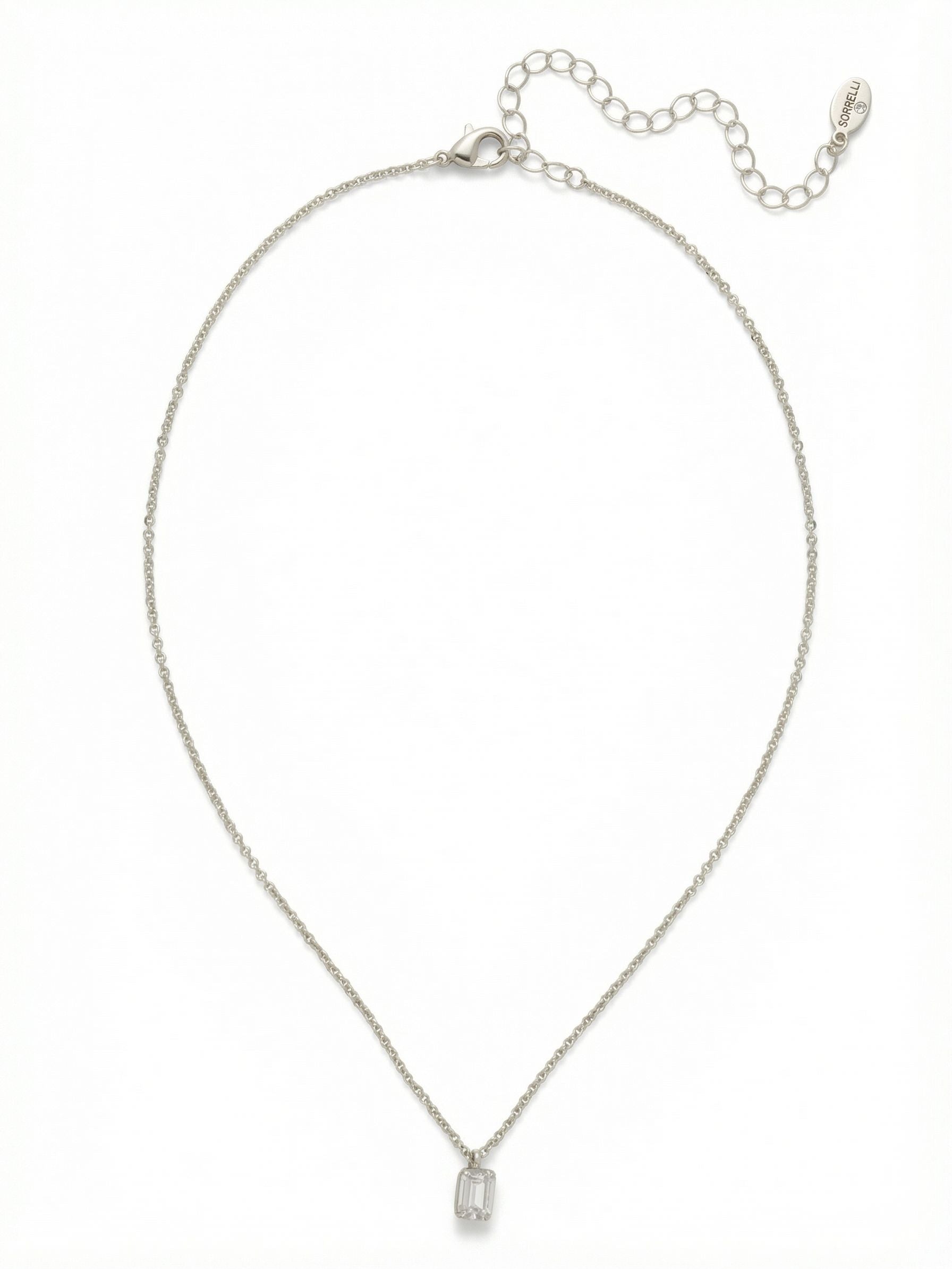 Petite Emerald Pendant Necklace - NFM13PDCRY - <p>A solitary emerald-cut crystal catches the light on a fine cable chain. The crisp, geometric lines of the clear stone offer a quiet presence that works seamlessly alone or layered with varying lengths of chain. Weighing very little, the minimalist pendant finds a comfortable resting point near the collarbone. An adjustable extension chain lets you tailor the drop to complement different necklines, making this an easy, refined staple for your daily rotation.</p><ul>
<li>Crisp emerald-cut profile creates clean geometric flashes of light</li>
<li>Delicate cable chain construction that rests effortlessly on the skin</li>
<li>Lobster claw clasp</li>
<li>4-inch adjustable extension chain</li>
<li>Protective e-coat finish for lasting wear</li>
<li>Includes signature organza pouch for gifting and travel</li>
</ul>