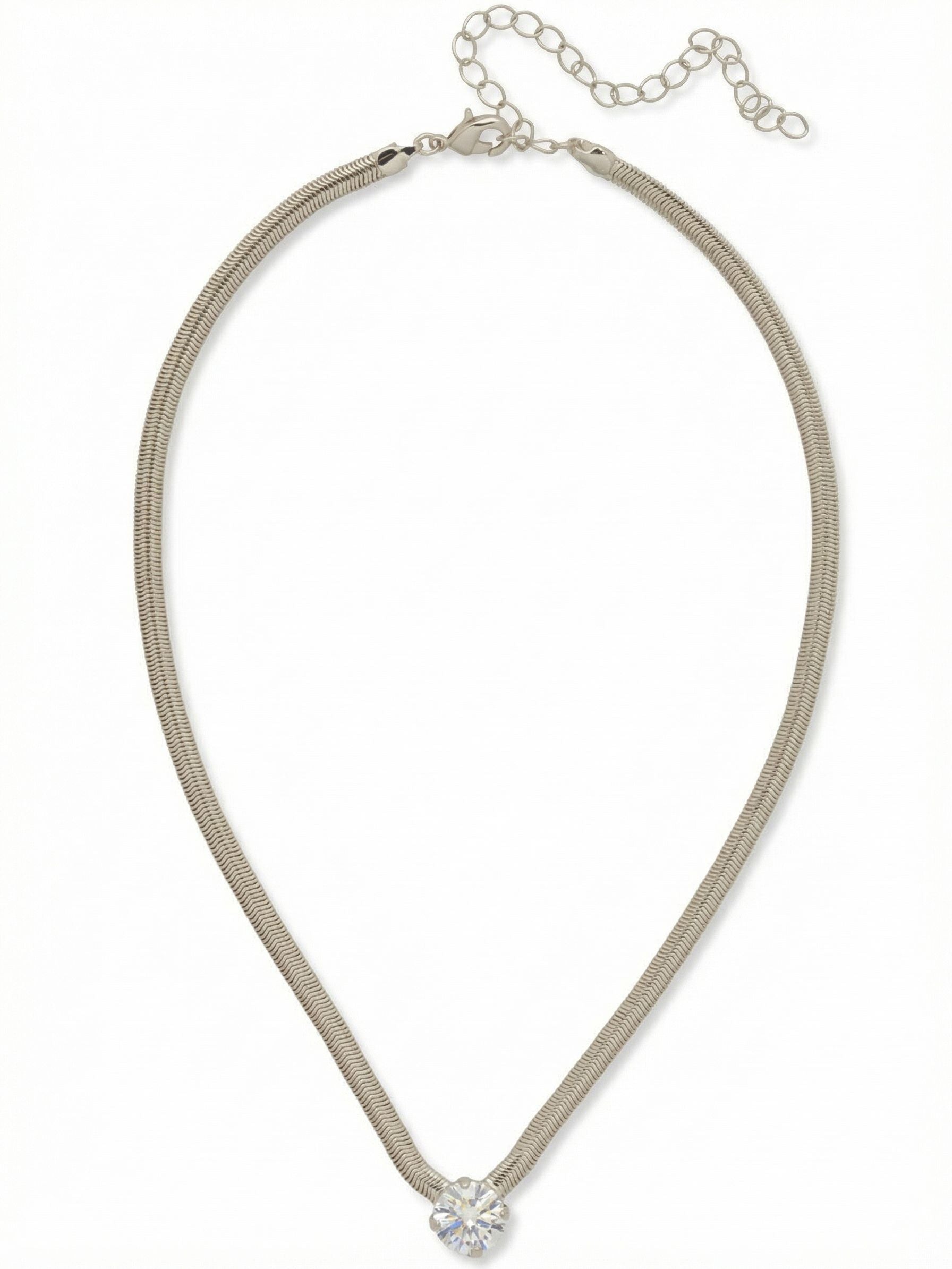 Rowan Pendant Necklace - NFP17PDCRY - <p>A single, substantial round crystal anchors this refined design. The fluid snake chain drapes with a satisfying weight, contouring naturally to the collarbone. With a continuous line of metal guiding the eye directly to the center stone, the piece wears like an updated classic. An integrated extension chain allows you to adjust the drop to suit your neckline. It brings a clean, modern presence to your daily rotation.</p><ul>
<li>Fluid snake chain that drapes seamlessly along the collarbone</li>
<li>Single oversized round crystal anchoring the sleek metal line</li>
<li>Lobster claw clasp</li>
<li>4-inch adjustable extension chain</li>
<li>Protective e-coat finish for lasting wear</li>
<li>Includes signature organza pouch for gifting and travel</li>
</ul>