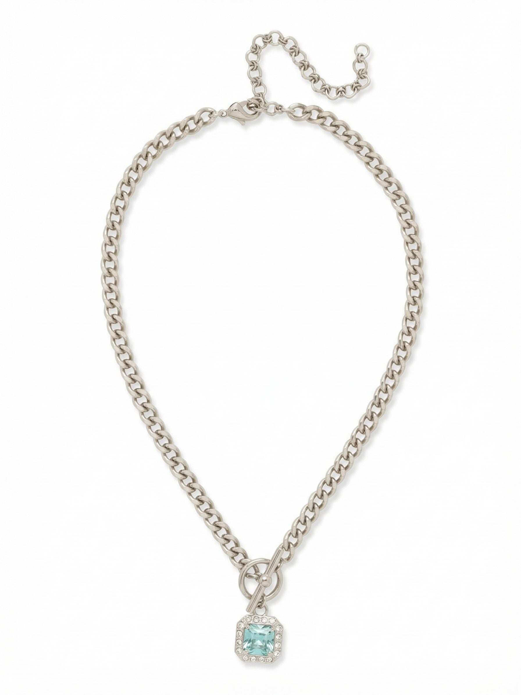 Autumn Pendant Necklace - NFS5PDAQU - <p>A substantial cable chain gives this necklace a satisfying weight that drapes with intention at the collarbone. The center design pairs a prominent metal ring with a single square-cut aquamarine crystal, balancing industrial hardware with clear watery light. The adjustable extension lets you tailor the drop to suit a simple neckline or a structured collar. It serves as a strong grounding anchor for your daily rotation.</p><ul>
<li>Substantial metal cable chain with front ring detail</li>
<li>Square-cut center crystal framed by a delicate halo</li>
<li>Lobster claw clasp</li>
<li>4-inch adjustable extension chain</li>
<li>Protective e-coat finish for lasting wear</li>
<li>Includes signature organza pouch for gifting and travel</li>
</ul>