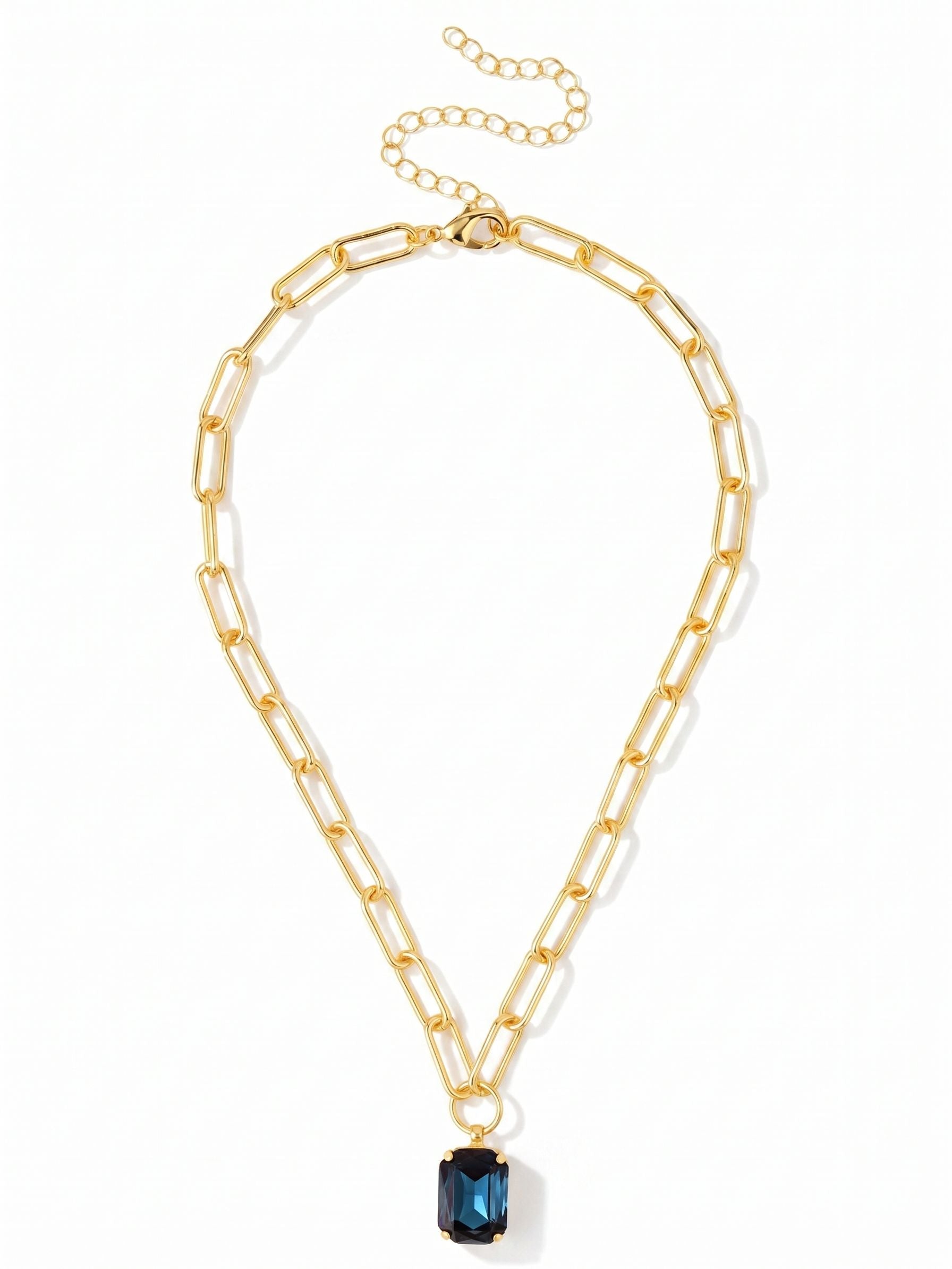 Brynn Paperclip Pendant Necklace - NFS78BGMON - <p>A substantial paperclip chain anchors a single, sizable emerald-cut crystal in deep, watery blue. The open metal links provide a satisfying, tactile weight that drapes easily across the collarbone, grounding the crisp geometry of the stone. An integrated extension chain lets you adjust the drop, making it simple to find the right placement whether worn solo against bare skin or stacked naturally with finer strands.</p><ul>
<li>Large emerald-cut crystal pendant on a structural paperclip chain</li>
<li>Crisp geometric stone contrasts with open metal links</li>
<li>Lobster claw clasp</li>
<li>4-inch adjustable extension chain</li>
<li>Protective e-coat finish for lasting wear</li>
<li>Includes signature organza pouch for gifting and travel</li>
</ul>