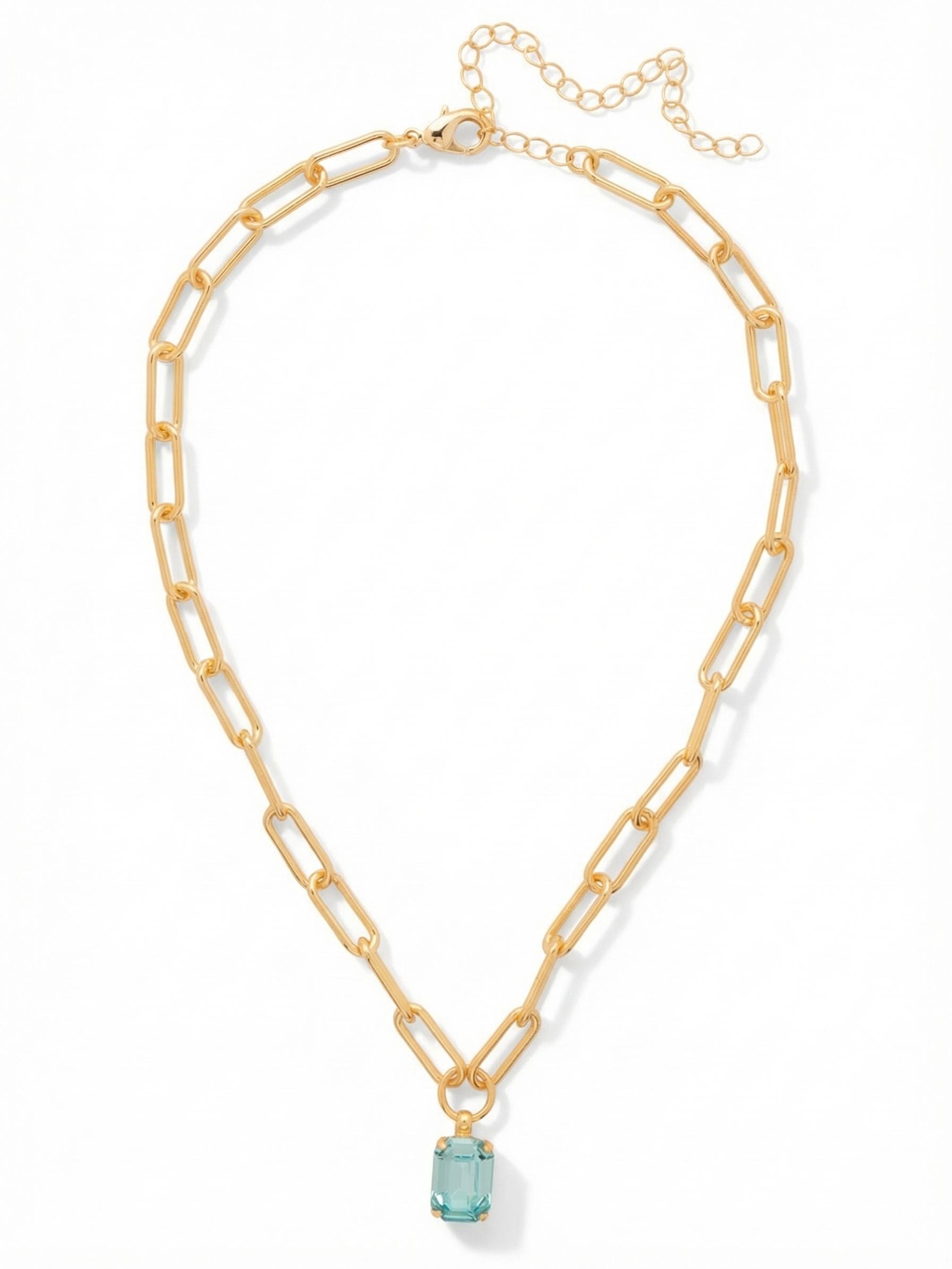 Nia Pendant Necklace - NFS7BGAQU - <p>A singular emerald-cut aquamarine crystal anchors this substantial paperclip chain. The elongated geometric links offer a satisfying weight that drapes comfortably across the collarbone. Suspended freely from a simple center ring, the solitary crystal catches the light with clean, architectural flashes rather than overwhelming sparkle. The included extension chain allows you to easily tailor the drop, making this a grounding piece to wear alone over a bare neckline or layer with finer chains.</p><ul>
<li>Elongated paperclip links provide a structured geometric contrast</li>
<li>Solitary emerald-cut crystal delivers clean linear sparkle</li>
<li>Lobster claw clasp</li>
<li>4-inch adjustable extension chain</li>
<li>Protective e-coat finish for lasting wear</li>
<li>Includes signature organza pouch for gifting and travel</li>
</ul>