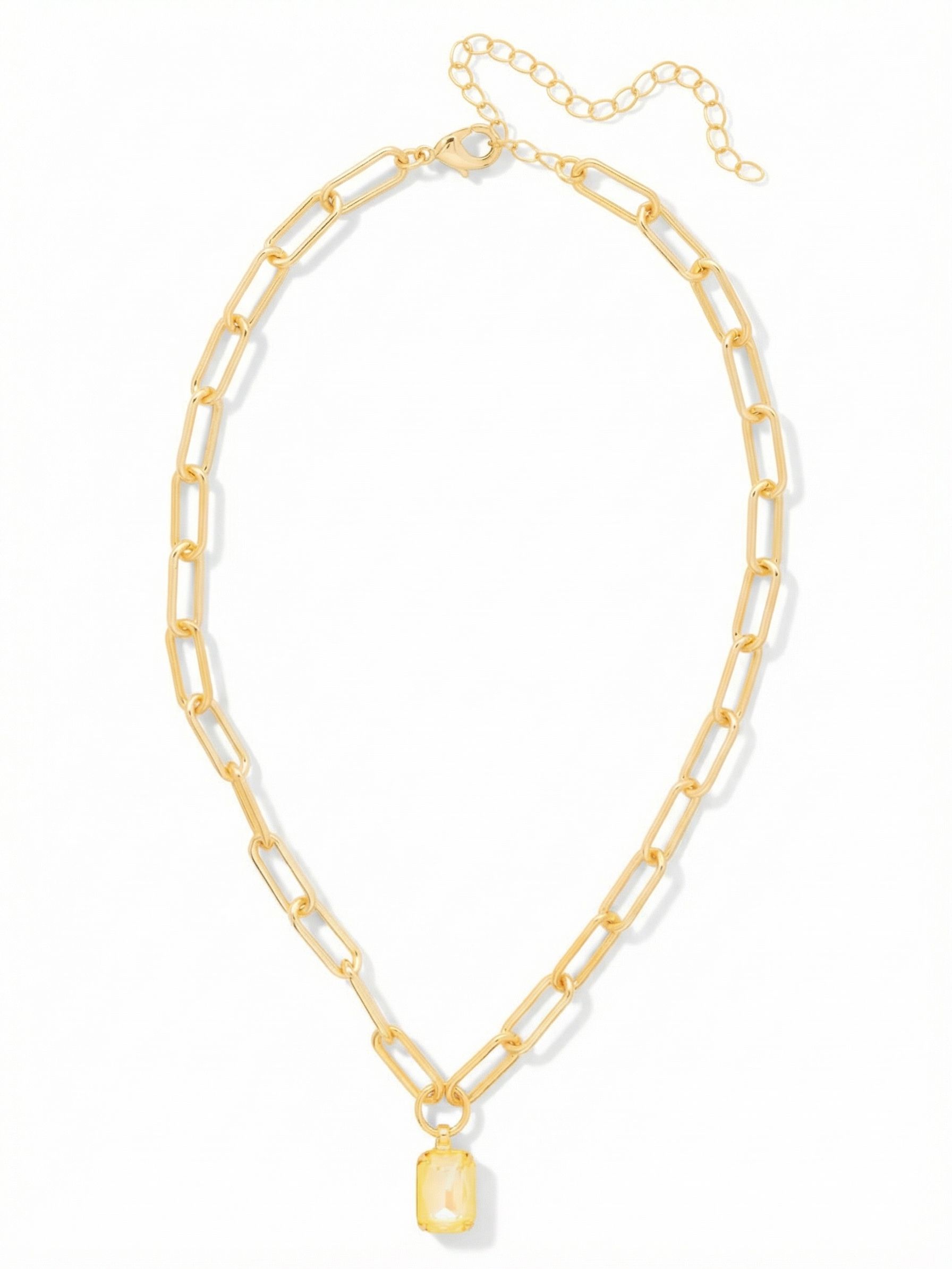 Nia Pendant Necklace - NFS7BGLTD - <p>A single emerald-cut crystal anchors an airy paperclip chain. The pale yellow stone blends seamlessly with the bright gold-tone links, creating a wash of warm, continuous color. The open geometric links provide subtle texture without feeling heavy around the neck. Resting right at the collarbone, the faceted pendant catches light with your natural movement. An extension chain lets you adjust the drop, making this an adaptable foundation piece for layering or a clean accent worn on its own.</p><ul>
<li>Lightweight paperclip chain construction</li>
<li>Emerald-cut focal crystal in a minimalist setting</li>
<li>Lobster claw clasp</li>
<li>4-inch adjustable extension chain</li>
<li>Protective e-coat finish for lasting wear</li>
<li>Includes signature organza pouch for gifting and travel</li>
</ul>
