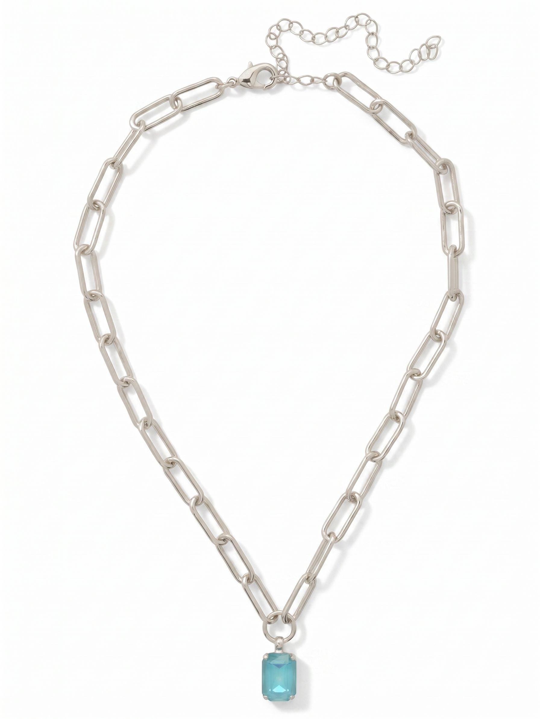 Nia Pendant Necklace - NFS7PDSBD - <p>The Nia Pendant suspends a single emerald-cut crystal from a modern paperclip chain. The elongated open links give the piece a lightweight, architectural feel that drapes cleanly across the collarbone. At the center, the geometric summer blue stone catches the light, bringing a crisp wash of color to your neckline. Built with an extension chain, the length easily adjusts to sit exactly where you want it, making it a natural companion for layered styling or wearing solo.</p><ul>
<li>Elongated paperclip chain links create an airy, modern rhythm</li>
<li>Solitary emerald-cut crystal delivers a clean geometric pop of color</li>
<li>Lobster claw clasp</li>
<li>4-inch adjustable extension chain</li>
<li>Protective e-coat finish for lasting wear</li>
<li>Includes signature organza pouch for gifting and travel</li>
</ul>