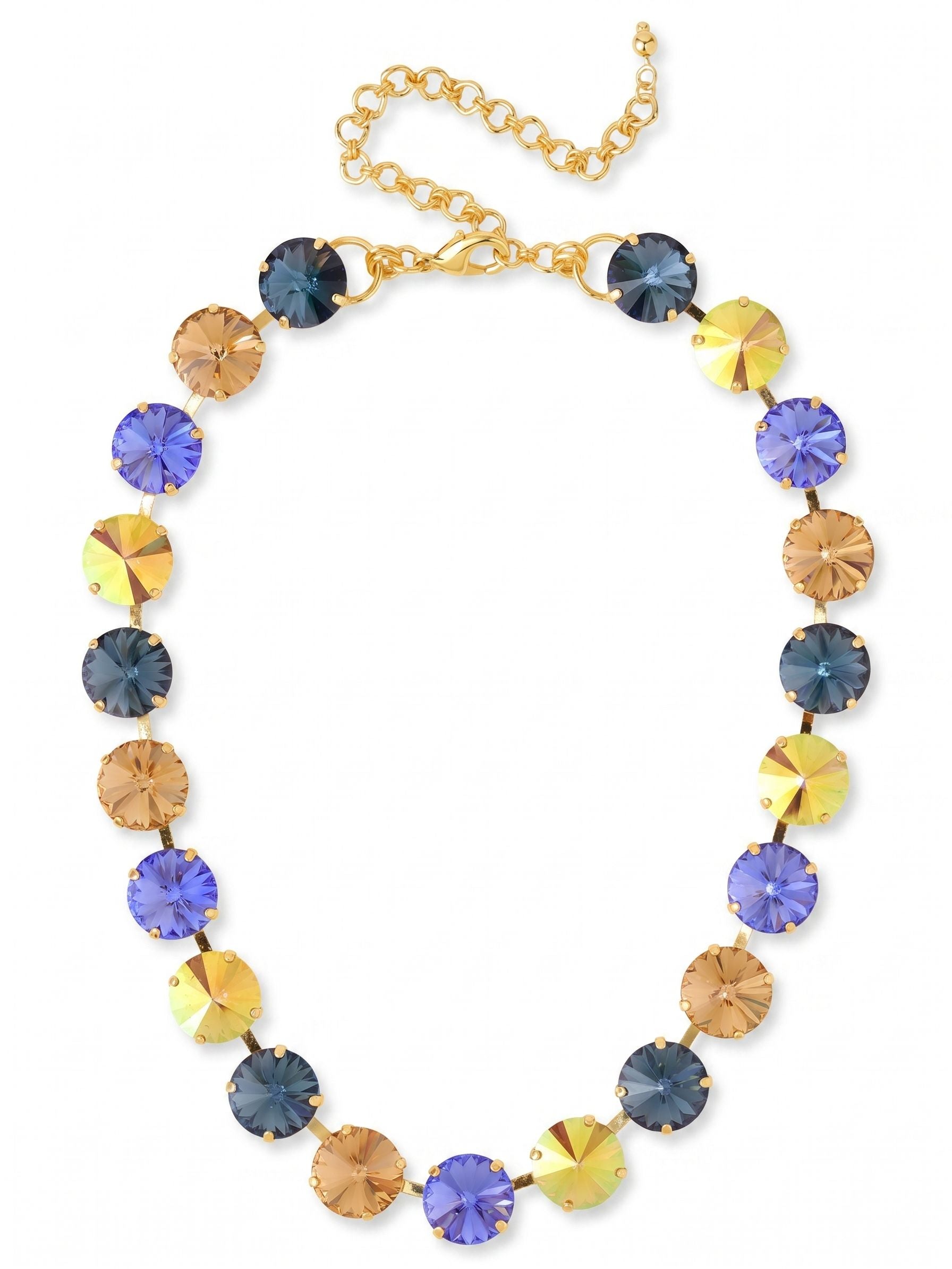 Nadine Tennis Necklace - NFU3BGDNM - <p>Substantial round crystals bring immediate presence to the collarbone. Deep indigo and sapphire tones shift into warm amber and iridescent gold, creating a rhythm of color that catches light as you move. The half-inch stones are connected by a flexible channel chain, giving the heavy crystal weight a soft, fluid drape along the neckline. An included extension chain lets you adjust the drop, allowing it to frame a bare neckline or layer neatly over a fitted knit.</p><ul>
<li>Oversized round crystals create a bold collarbone statement</li>
<li>Alternating warm amber and deep blue tones offer a rich visual rhythm</li>
<li>Lobster claw clasp</li>
<li>4-inch adjustable extension chain</li>
<li>Protective e-coat finish for lasting wear</li>
<li>Includes signature organza pouch for gifting and travel</li>
</ul>