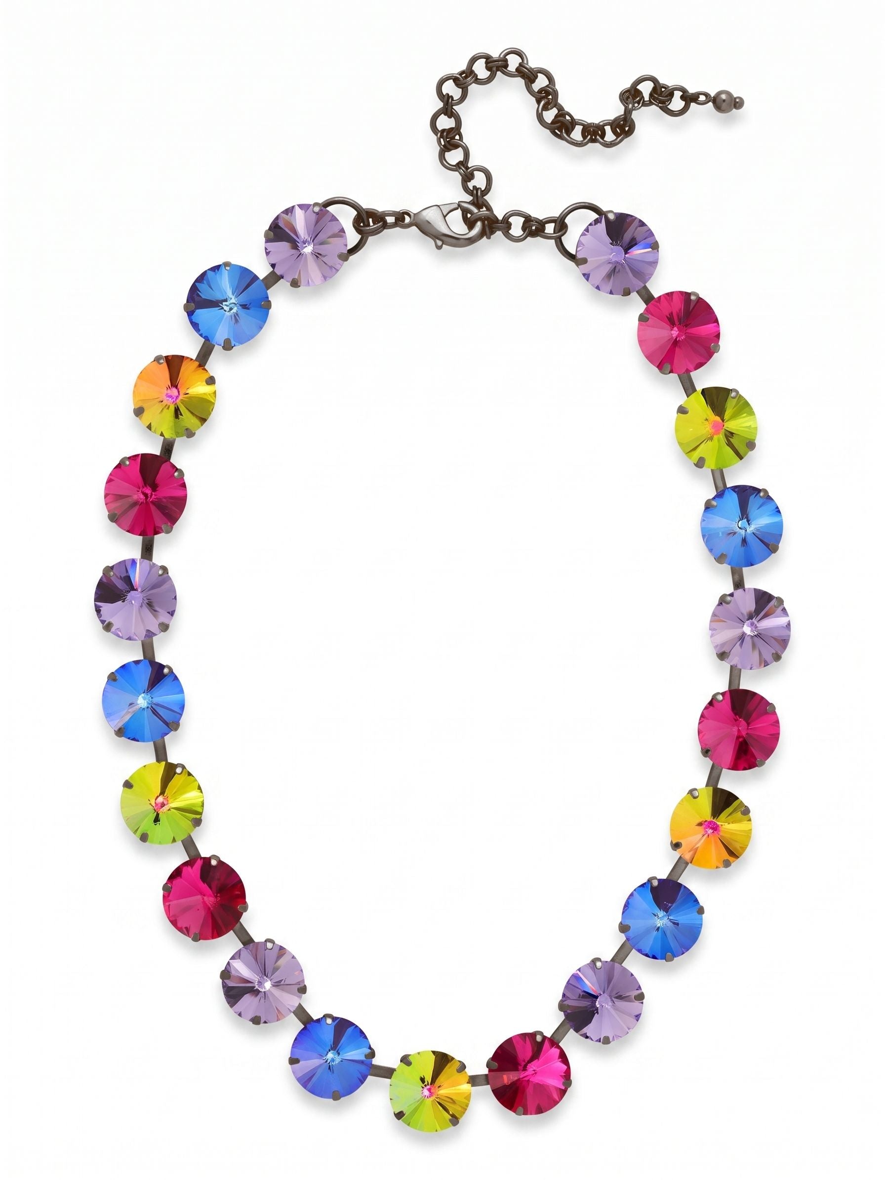 Nadine Tennis Necklace - NFU3GMNNI - <p>Large round-cut crystals form a vivid line of color at the collarbone. The Nadine Tennis Necklace contrasts deep gunmetal with bright fuchsia, tanzanite, and shifting volcano crystals. Constructed on a flexible chain, the half-inch width gives it substantial weight that drapes cleanly. It sits close to the neck for immediate impact, while the extension chain provides room to adjust the drop to suit different necklines. The dark metal finish grounds the saturated palette, making it a natural choice to wear with a cashmere sweater or an open collar.</p><ul>
<li>Half-inch round crystals offer substantial scale and saturated color</li>
<li>Flexible chain construction ensures the necklace drapes evenly</li>
<li>Lobster claw clasp</li>
<li>4-inch adjustable extension chain</li>
<li>Includes signature organza pouch for gifting and travel</li>
</ul>