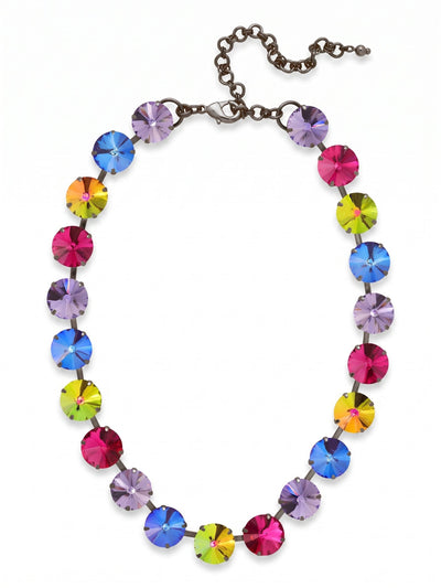 Nadine Tennis Necklace - NFU3GMNNI - <p>Large round-cut crystals form a vivid line of color at the collarbone. The Nadine Tennis Necklace contrasts deep gunmetal with bright fuchsia, tanzanite, and shifting volcano crystals. Constructed on a flexible chain, the half-inch width gives it substantial weight that drapes cleanly. It sits close to the neck for immediate impact, while the extension chain provides room to adjust the drop to suit different necklines. The dark metal finish grounds the saturated palette, making it a natural choice to wear with a cashmere sweater or an open collar.</p><ul>
<li>Half-inch round crystals offer substantial scale and saturated color</li>
<li>Flexible chain construction ensures the necklace drapes evenly</li>
<li>Lobster claw clasp</li>
<li>4-inch adjustable extension chain</li>
<li>Includes signature organza pouch for gifting and travel</li>
</ul>