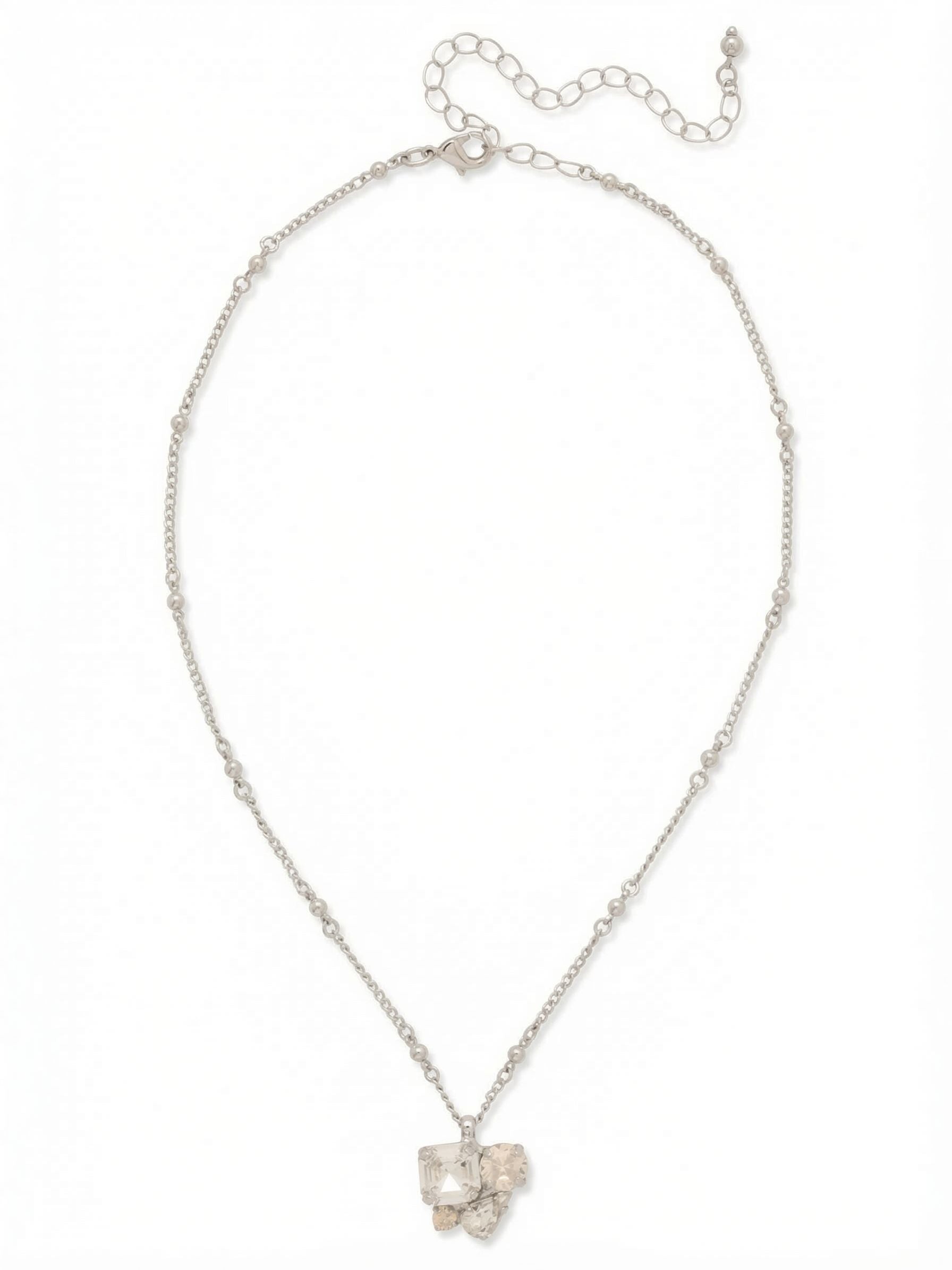 Anika Pendant Necklace - NFY110PDCLA - <p>An asymmetrical cluster of clear and white opal crystals anchors this delicate pendant. The deliberate mix of square, round, and pear cuts creates a varied geometry that catches the light from multiple angles. Suspended from a slender beaded cable chain, the piece rests comfortably near the collarbone. An attached extension chain allows you to tailor the drop to an open neckline or position it precisely among longer strands in your rotation.</p><ul>
<li>Asymmetrical cluster mixing square, round, and pear cuts</li>
<li>Slender cable chain punctuated with spaced metallic beads</li>
<li>Lobster claw clasp</li>
<li>4-inch adjustable extension chain</li>
<li>Protective e-coat finish for lasting wear</li>
<li>Includes signature organza pouch for gifting and travel</li>
</ul>