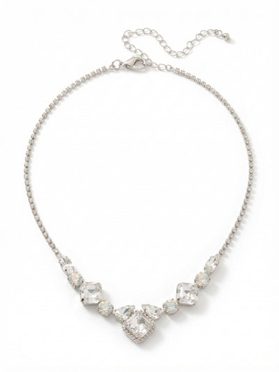 Izzy Crystal Chain Tennis Necklace - NFY400PDCLA - <p>A delicate line of rhinestone chain descends into a concentrated arrangement of light and texture. Sharp square crystals anchor the center, balanced by the softer presence of milky white opals and clear pear cuts. This combination of geometric shapes and contrasting clarities draws the eye directly to the collarbone. Built with a generous extension chain, the necklace adjusts to complement a crisp buttoned shirt or a draped neckline, bringing a quiet focus to your daily rotation.</p><ul>
<li>Contrast of sharp geometric crystal cuts against soft white opals</li>
<li>Delicate rhinestone chain culminating in a complex central motif</li>
<li>Lobster claw clasp</li>
<li>4-inch adjustable extension chain</li>
<li>Protective e-coat finish for lasting wear</li>
<li>Includes signature organza pouch for gifting and travel</li>
</ul>