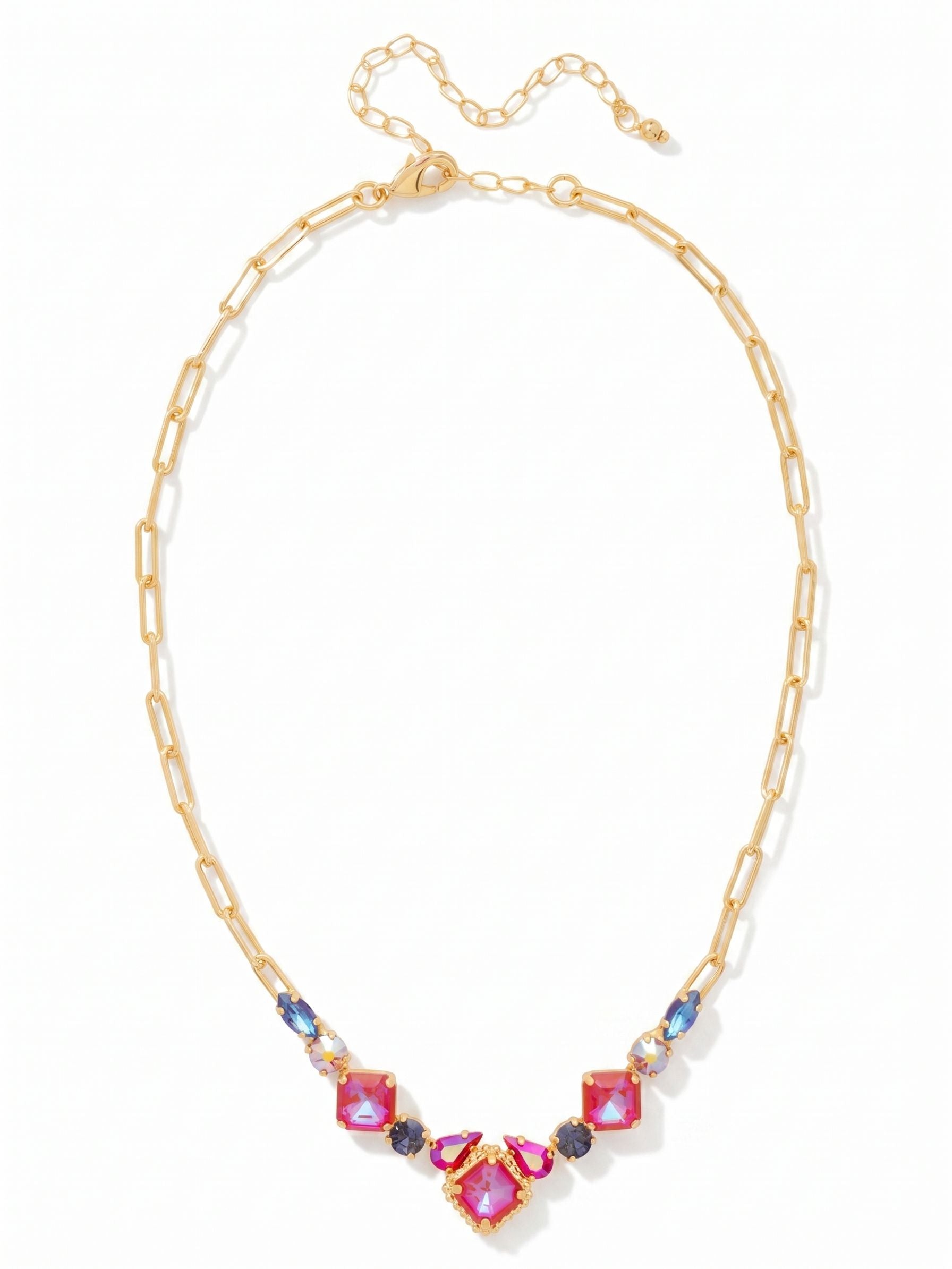 Izzy Tennis Necklace - NFY40BGREV - <p>An airy paperclip chain anchors a rich cluster of jewel tones right at the collarbone. Square cuts of vibrant red ground a gradient of deep violet and shimmering pink crystals, catching the light easily as you move. The open metal links keep the piece feeling light and modern against the skin. An adjustable extension chain lets you dial in the exact drop, allowing it to rest perfectly inside an open collar or sit naturally over a simple knit.</p><ul>
<li>Modern open paperclip chain contrasts with dense crystal arrangements</li>
<li>Focal cluster mixes square, pear, and round crystal cuts</li>
<li>Lobster claw clasp</li>
<li>4-inch adjustable extension chain</li>
<li>Protective e-coat finish for lasting wear</li>
<li>Includes signature organza pouch for gifting and travel</li>
</ul>