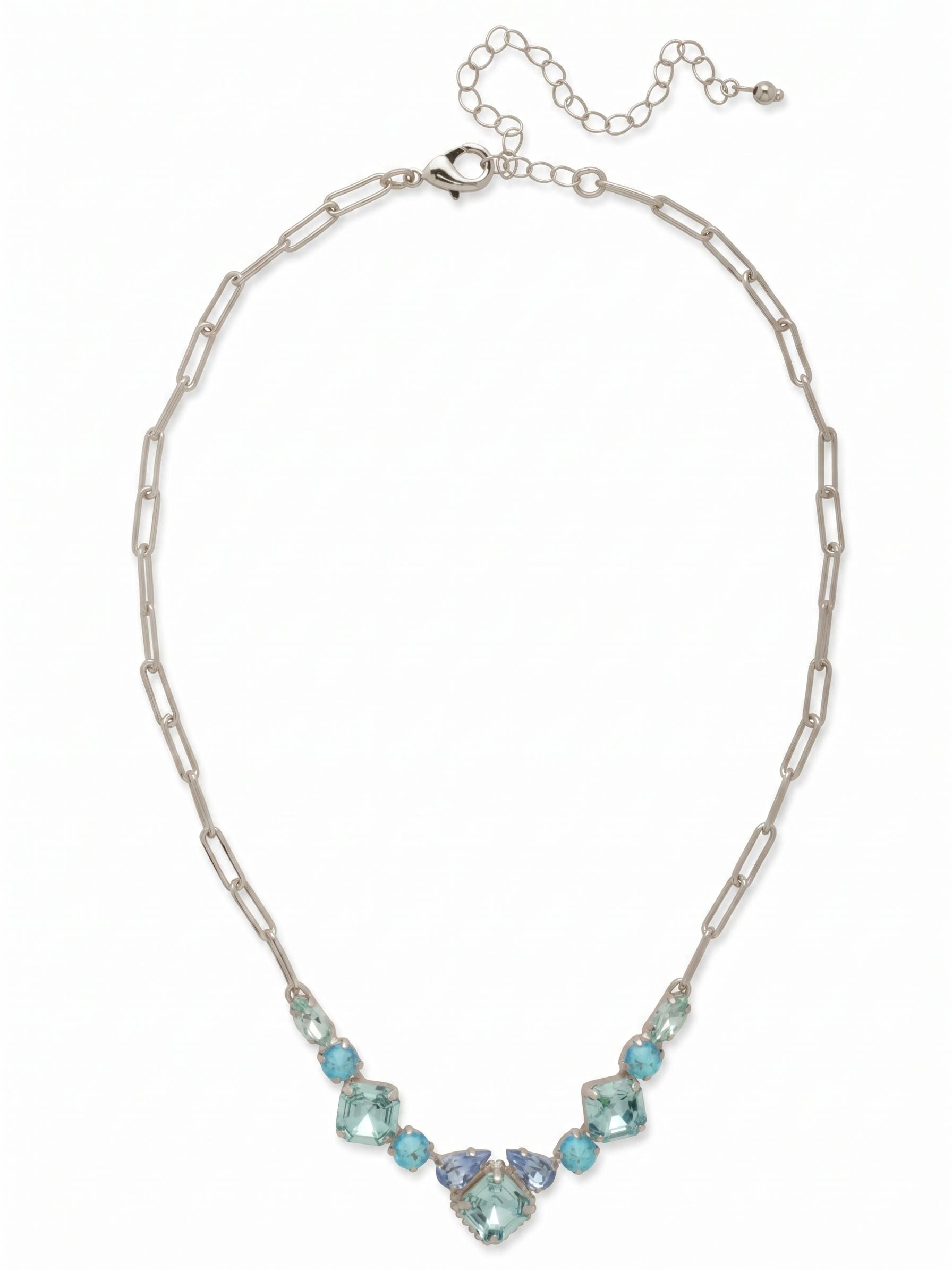Izzy Tennis Necklace - NFY40PDOC - <p>A focal point of square, pear, and round crystals anchors the collarbone, catching the light with cool, watery precision. Rather than a continuous line of stones, the geometric motif transitions into an airy paperclip chain that drapes naturally around the neckline. It delivers the presence of a classic tennis silhouette but with a much lighter daily feel. The built-in adjustability lets you place the drop exactly where you want it, suiting an open collar or a simple crew neck.</p><ul>
<li>Central focal motif mixing square, pear, and round crystal cuts</li>
<li>Airy paperclip chain provides a lighter take on the classic tennis profile</li>
<li>Lobster claw clasp</li>
<li>4-inch adjustable extension chain</li>
<li>Protective e-coat finish for lasting wear</li>
<li>Includes signature organza pouch for gifting and travel</li>
</ul>