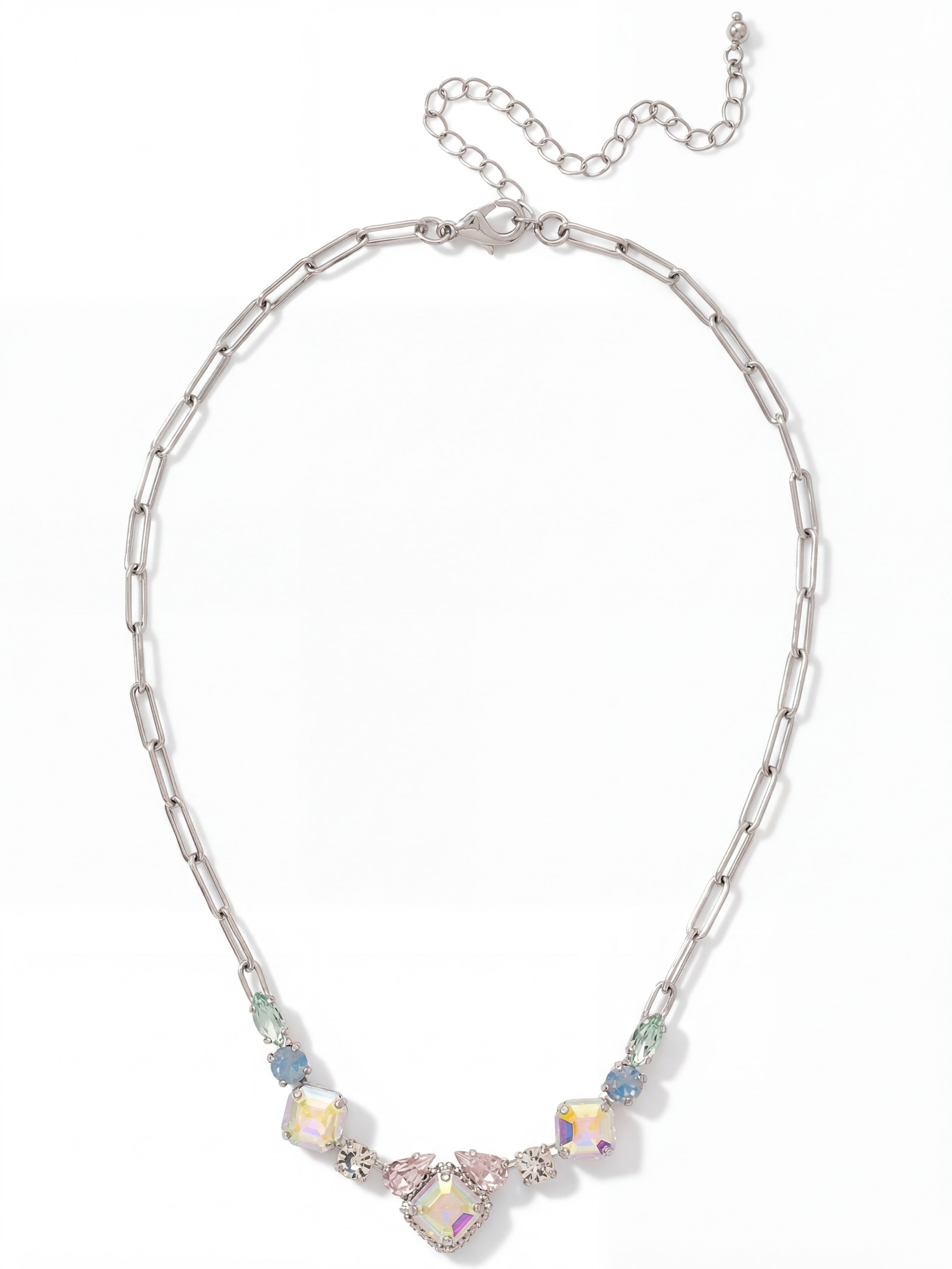 Izzy Tennis Necklace - NFY40PDRQ - <p>Clean paperclip links shift into a softly curved arrangement of mixed-cut crystals sitting right at the collarbone. Iridescent square stones cast a gentle glow alongside muted blue opals and delicate pear shapes. The varied crystal cuts give this piece a balanced weight that rests securely across the chest. It offers a subtle wash of pastel color that frames the face in natural light. An extension chain lets you adjust the drop to complement your specific neckline.</p><ul>
<li>Modern paperclip links transition into a concentrated collar of mixed crystal shapes</li>
<li>Symmetrical progression of square, pear, and marquise cuts framing the center</li>
<li>Lobster claw clasp</li>
<li>4-inch adjustable extension chain</li>
<li>Protective e-coat finish for lasting wear</li>
<li>Includes signature organza pouch for gifting and travel</li>
</ul>