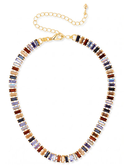 Bianca Choker Tennis Necklace - NFY55BGDNM - <p>A tightly linked ribbon of baguette-cut crystals wraps high around the collarbone, creating a tailored, structured look that still moves fluidly. The repeating pattern alternates between cool deep sapphire tones and warm golden amber, catching the light in solid geometric flashes rather than scattered sparkles. The flexible channel-set design conforms naturally to the contours of your neckline. It brings a grounded, architectural presence to a simple white button-down or an evening blazer.</p><ul>
<li>Repeating pattern of cool sapphire and warm topaz baguette crystals</li>
<li>Flexible channel-set chain construction creates a fluid drape</li>
<li>Lobster claw clasp</li>
<li>4-inch adjustable extension chain</li>
<li>Protective e-coat finish for lasting wear</li>
<li>Includes signature organza pouch for gifting and travel</li>
</ul>