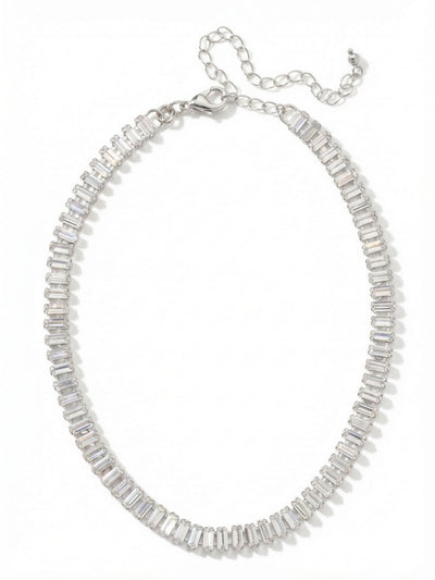 Bianca Choker Tennis Necklace - NFY55PDCRY - <p>The Bianca Choker places a continuous sequence of clear baguette crystals directly at the base of the neck. Set closely together in an articulated channel chain, the stones flex naturally to map the curve of your collarbone. Baguette crystals offer a step-cut facet, creating a clean, mirrored flash rather than a scattered sparkle. With an included extension chain, you can wear this piece high as a structured collar or let it drop slightly to anchor a layered look.</p><ul>
<li>Articulated channel chain allows the sequence of stones to flex naturally</li>
<li>Step-cut baguette faceting provides a sleek, mirrored reflection</li>
<li>Lobster claw clasp</li>
<li>4-inch adjustable extension chain</li>
<li>Protective e-coat finish for lasting wear</li>
<li>Includes signature organza pouch for gifting and travel</li>
</ul>