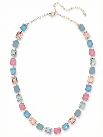 Octavia Repeating Tennis Necklace - NFY7PDPBZ - <p>An unbroken line of emerald-cut crystals creates a cool, rhythmic palette of soft blues, teals, and pale rose. Set tightly together in a specialized channel chain, the uniform rectangular stones form a fluid band of color that conforms naturally to the collarbone. Instead of scattering light, the broad step-cut facets catch it in steady, even flashes as you move. An adjustable extension lets you drop the length exactly where you want it, easily anchoring the open collar of a silk blouse or resting higher on the neck.</p><ul>
<li>Stepped facets of the emerald-cut stones catch light cleanly along the neckline</li>
<li>Fluid channel chain construction allows the continuous crystal line to drape organically</li>
<li>Lobster claw clasp</li>
<li>4-inch adjustable extension chain</li>
<li>Protective e-coat finish for lasting wear</li>
<li>Includes signature organza pouch for gifting and travel</li>
</ul>