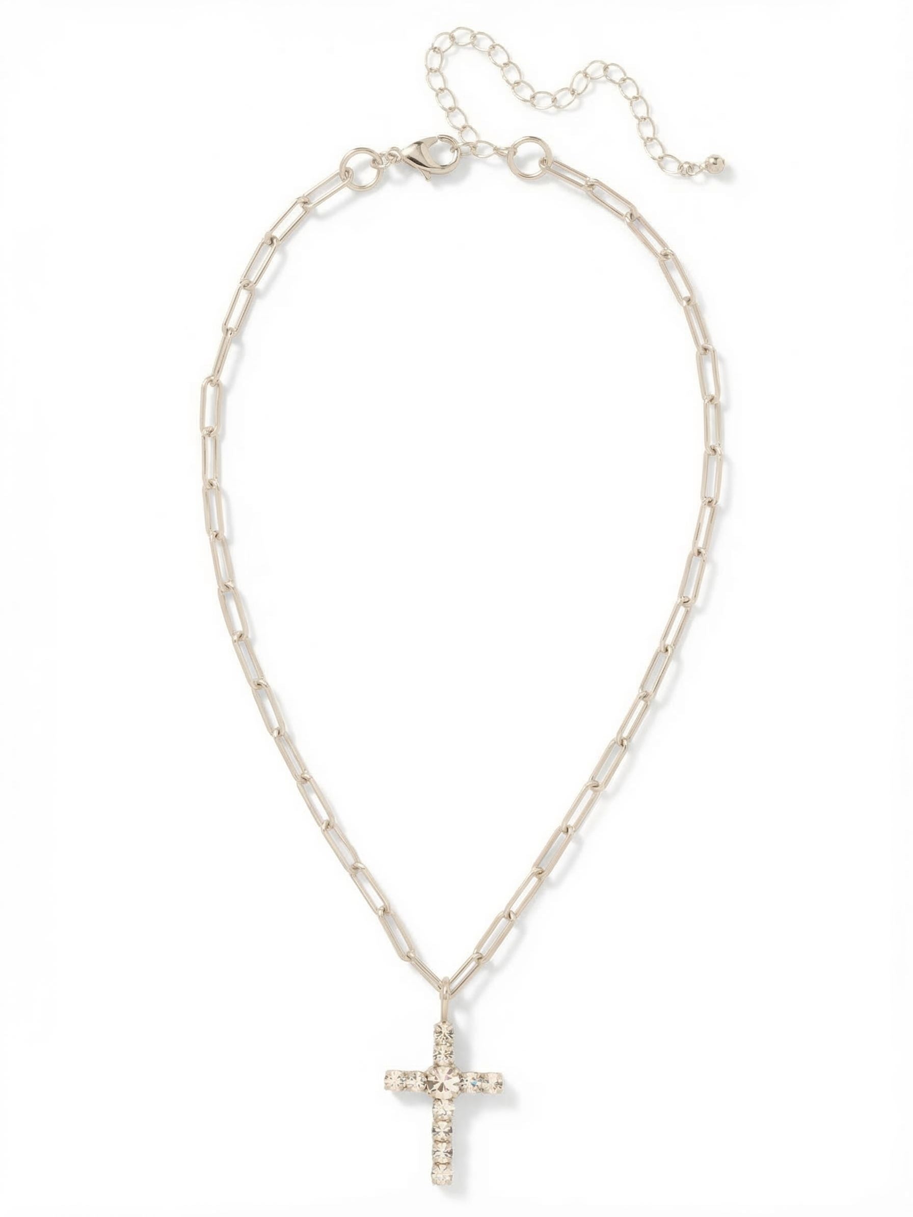 Cross Paperclip Pendant Necklace - NFZ11PDCRY - <p>Ten small round-cut clear crystals surround a larger center stone to form a balanced, classic cross pendant. It hangs from a structural paperclip chain, offering an unexpected contrast between the traditional crystal layout and modern open links. The chain drapes fluidly at the neckline, catching the light as you move. An integrated extension chain lets you adjust the drop, allowing this piece to layer effortlessly or stand quietly on its own.</p><ul>
<li>Structural paperclip links provide a modern contrast to the classic pendant</li>
<li>A single larger center stone anchors the clear crystal cross</li>
<li>Lobster claw clasp</li>
<li>4-inch adjustable extension chain</li>
<li>Protective e-coat finish for lasting wear</li>
<li>Includes signature organza pouch for gifting and travel</li>
</ul>
