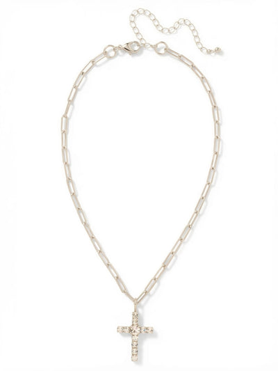 Cross Paperclip Pendant Necklace - NFZ11PDCRY - <p>Ten small round-cut clear crystals surround a larger center stone to form a balanced, classic cross pendant. It hangs from a structural paperclip chain, offering an unexpected contrast between the traditional crystal layout and modern open links. The chain drapes fluidly at the neckline, catching the light as you move. An integrated extension chain lets you adjust the drop, allowing this piece to layer effortlessly or stand quietly on its own.</p><ul>
<li>Structural paperclip links provide a modern contrast to the classic pendant</li>
<li>A single larger center stone anchors the clear crystal cross</li>
<li>Lobster claw clasp</li>
<li>4-inch adjustable extension chain</li>
<li>Protective e-coat finish for lasting wear</li>
<li>Includes signature organza pouch for gifting and travel</li>
</ul>