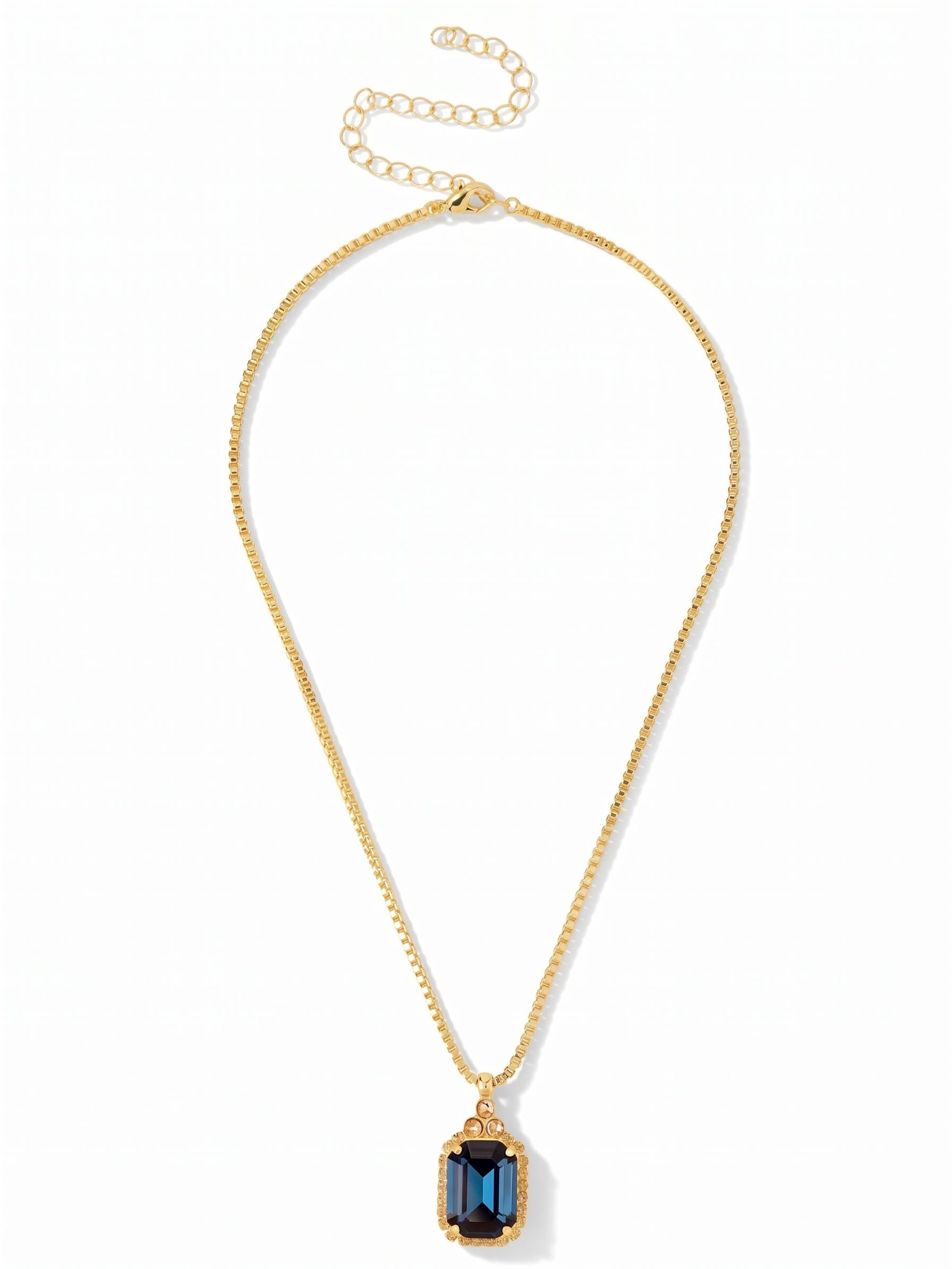 Brynn Embellished Pendant Necklace - NFZ150BGDNM - <p>A quiet anchor for your daily layering. The sleek geometry of a box chain leads down to a substantial deep blue crystal, cut in a crisp emerald shape that catches the light with a calm, grounded weight. Above it, three smaller warm-toned round stones add a subtle shift in color. With the attached extension chain, you can easily adjust the drape to frame a silk camisole or rest right at the collar of a crisp button-down.</p><ul>
<li>Sleek box chain construction contrasts with the architectural cut of the center stone</li>
<li>Clustered round stones create a delicate visual bridge to the main pendant</li>
<li>Lobster claw clasp</li>
<li>4-inch adjustable extension chain</li>
<li>Protective e-coat finish for lasting wear</li>
<li>Includes signature organza pouch for gifting and travel</li>
</ul>