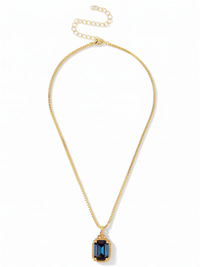 Brynn Embellished Pendant Necklace - NFZ150BGDNM - <p>A quiet anchor for your daily layering. The sleek geometry of a box chain leads down to a substantial deep blue crystal, cut in a crisp emerald shape that catches the light with a calm, grounded weight. Above it, three smaller warm-toned round stones add a subtle shift in color. With the attached extension chain, you can easily adjust the drape to frame a silk camisole or rest right at the collar of a crisp button-down.</p><ul>
<li>Sleek box chain construction contrasts with the architectural cut of the center stone</li>
<li>Clustered round stones create a delicate visual bridge to the main pendant</li>
<li>Lobster claw clasp</li>
<li>4-inch adjustable extension chain</li>
<li>Protective e-coat finish for lasting wear</li>
<li>Includes signature organza pouch for gifting and travel</li>
</ul>