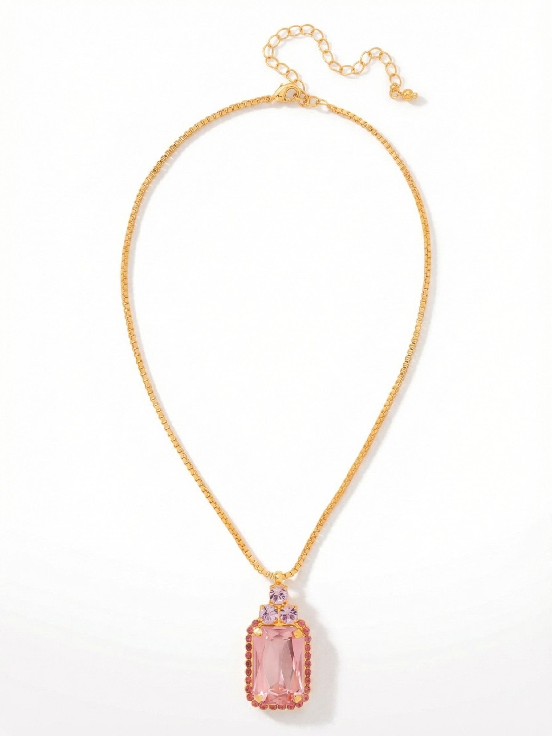 Viretta Embellished Pendant Necklace - NFZ155BGPRO - <p>An emerald-cut light rose crystal anchors this pendant, framed by subtle crystal detailing that brings a solid weight to the piece. This allows the fine box chain to drape naturally just below the collarbone. Three round violet crystals sit right above the center stone, catching the light as you move. The necklace rests with a grounded sense of warmth, while the built-in extension chain lets you easily adjust the drop to suit your neckline.</p><ul>
<li>Emerald-cut center stone bordered by a delicate crystal frame</li>
<li>Sleek box chain contrasts with the intricately detailed pendant</li>
<li>Lobster claw clasp</li>
<li>4-inch adjustable extension chain</li>
<li>Protective e-coat finish for lasting wear</li>
<li>Includes signature organza pouch for gifting and travel</li>
</ul>