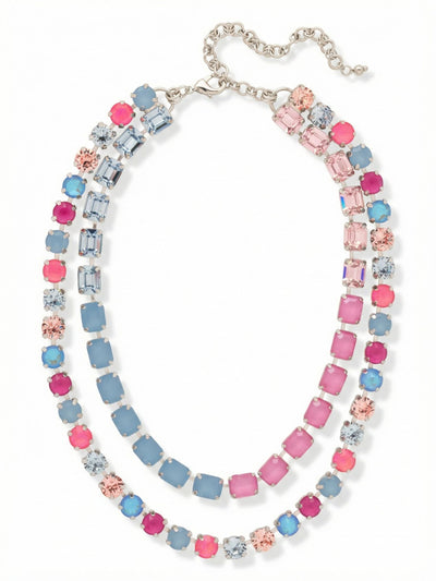 Marci Tennis Necklace - NFZ2PDPBZ - <p>The Marci Tennis Necklace delivers perfectly spaced layering in a single piece. An inner row of structured emerald-cut crystals rests near the collarbone, framed by an outer sweep of round-cut stones. The setting connects a vivid gradient of pink and blue tones, creating a deliberate color shift that catches light. Built on a flexible crystal-set chain, the design drapes comfortably without twisting. An integrated extension chain lets you precisely adjust the drop, bringing substantial weight and architectural symmetry to an open neckline.</p><ul>
<li>Double-row silhouette combining emerald cuts and round stones</li>
<li>Fluid color progression from vibrant pinks to muted blue opals</li>
<li>Lobster claw clasp</li>
<li>4-inch adjustable extension chain</li>
<li>Protective e-coat finish for lasting wear</li>
<li>Includes signature organza pouch for gifting and travel</li>
</ul>
