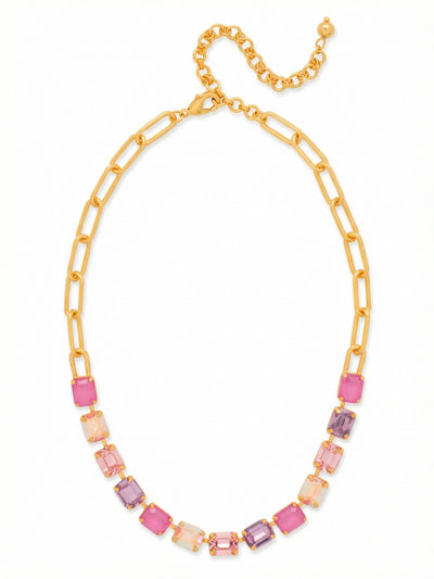 Octavia Paperclip Tennis Necklace - NFZ3BGPRO - <p>The Octavia Paperclip Tennis Necklace balances classic crystal presence with everyday ease. A focal line of emerald-cut stones rests securely below the collarbone, displaying an array of violet and pale rose tones. Instead of a continuous jeweled band, the back transitions into a modern bright gold-tone paperclip link, keeping the piece lightweight around the neck. The adjustable extension lets you alter the drop, making it simple to layer with longer strands or wear neatly inside an open collar.</p><ul>
<li>Hybrid construction blending an emerald-cut crystal row with an elongated paperclip chain</li>
<li>Step-cut faceted crystals arranged in alternating warm rose and violet tones</li>
<li>Lobster claw clasp</li>
<li>4-inch adjustable extension chain</li>
<li>Protective e-coat finish for lasting wear</li>
<li>Includes signature organza pouch for gifting and travel</li>
</ul>