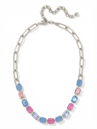 Octavia Paperclip Tennis Necklace - NFZ3PDPBZ - <p>A modern hybrid that merges everyday metalwork with focused color. The Octavia grounds a vibrant arc of emerald-cut crystals in bright blues and deep pinks against a lightweight paperclip chain. The front channel rests along the collarbone, delivering solid flashes of color and light, while the elongated open links at the back keep the design feeling relaxed. An included extension chain lets you adjust the drape, making it easy to style alone or layer beneath shorter chains.</p><ul>
<li>Hybrid design combining open paperclip links with a crystal-set channel</li>
<li>Faceted emerald-cut crystals in vivid alternating blues and pinks</li>
<li>Lobster claw clasp</li>
<li>4-inch adjustable extension chain</li>
<li>Protective e-coat finish for lasting wear</li>
<li>Includes signature organza pouch for gifting and travel</li>
</ul>