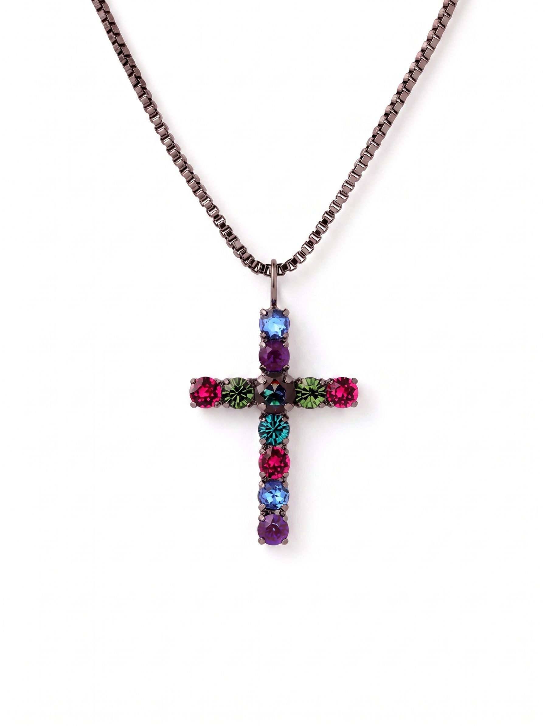Crystal Cross Pendant Necklace - NFZ90GMNNI - <p>This cross pendant anchors a vibrant spectrum of jewel-toned crystals against a dark, structured box chain. The larger central stone catches the light with a moody depth, surrounded by precise arrangements of fuchsia, emerald, and blue zircon. A gunmetal setting creates a sharp, modern contrast that keeps the bright stones grounded. Suspended on a fluid chain with an adjustable extension, the pendant finds its natural place resting just below the collarbone. It brings an assertive, colorful presence to a simple silk blouse or a dark knit.</p><ul>
<li>Symmetrical spectrum of vibrant crystals anchored by a larger central stone</li>
<li>Fluid box chain provides a sleek and structured drape</li>
<li>Lobster claw clasp</li>
<li>4-inch adjustable extension chain</li>
<li>Includes organza pouch for gifting and travel</li>
</ul>