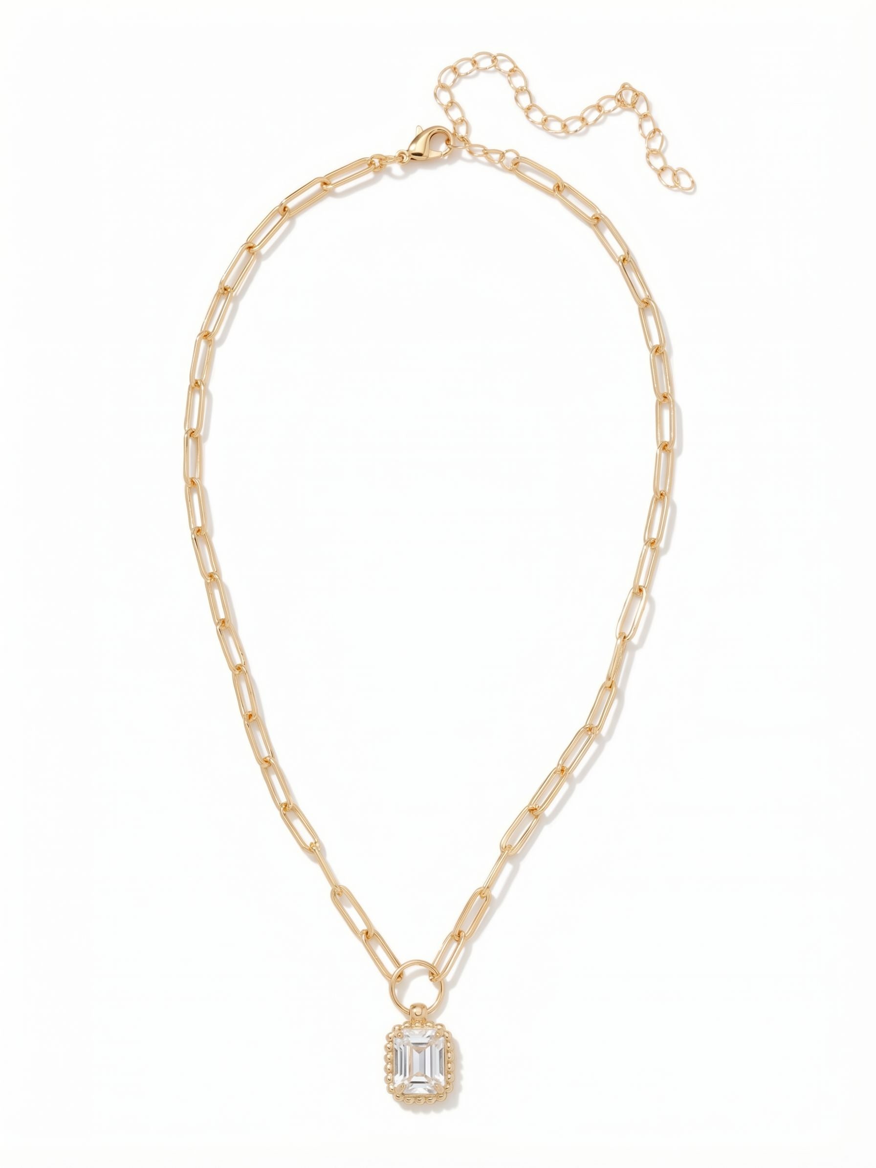 Octavia Scalloped Pendant Necklace - NGA1BGCRY - <p>A single emerald-cut crystal provides clean flashes of light within a softly textured scalloped border. It drops from a modern paperclip chain, balancing airy, elongated links against the distinct weight of the center stone. Attached by a simple ring connector, the pendant moves freely with you. The extension chain lets you adjust the drape perfectly, making this necklace a versatile foundational piece that works beautifully alone or mixed with other chains.</p><ul>
<li>Emerald-cut center crystal bordered by delicate beaded detailing</li>
<li>Elongated paperclip chain creates an airy visual contrast</li>
<li>Lobster claw clasp</li>
<li>4-inch adjustable extension chain</li>
<li>Protective e-coat finish for lasting wear</li>
<li>Includes signature organza pouch for gifting and travel</li>
</ul>