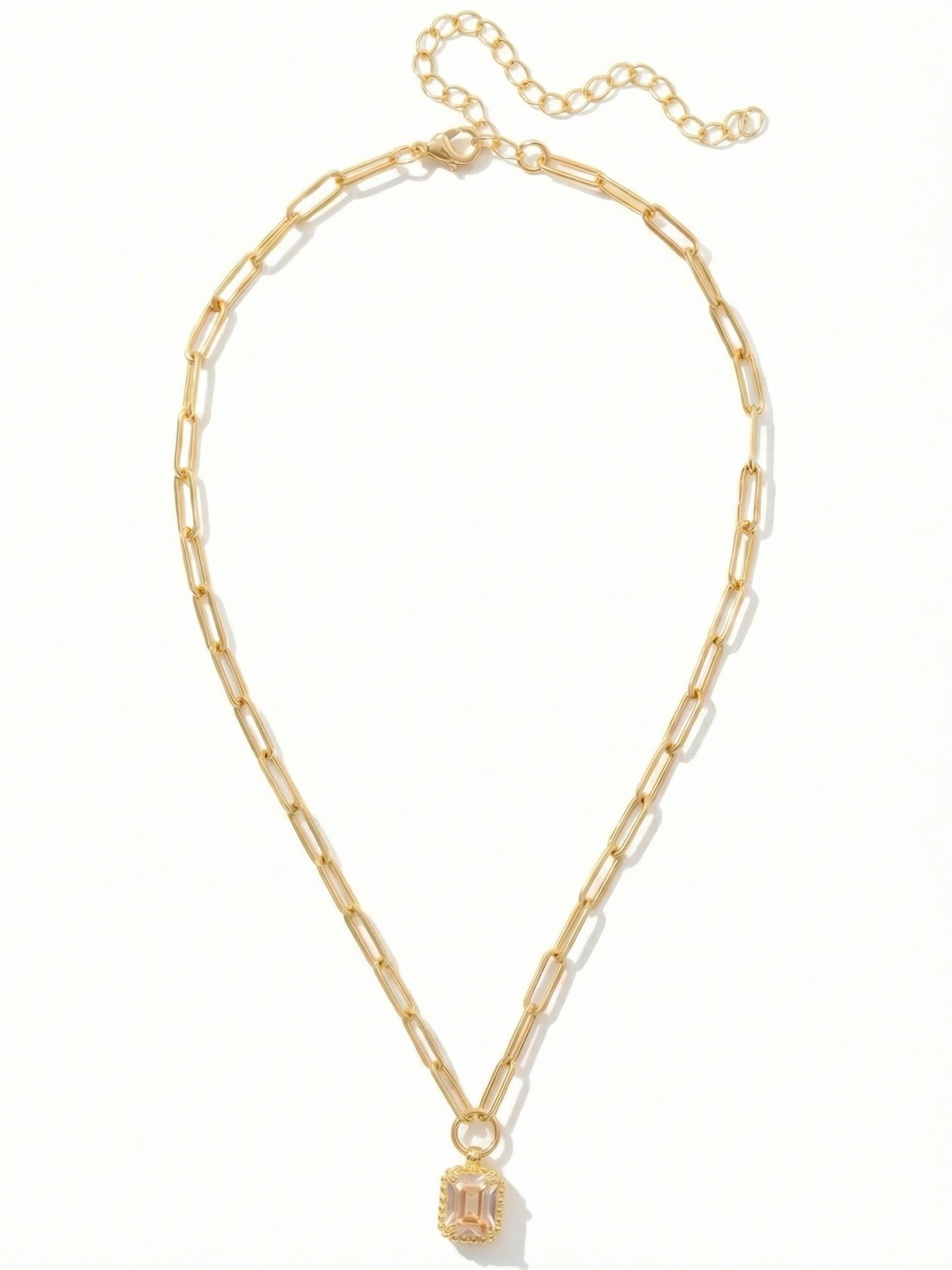 Octavia Scalloped Pendant Necklace - NGA1BGGNS - <p>A single emerald-cut crystal anchors this piece, bringing a quiet wash of warm light to the neckline. Suspended from an open paperclip chain, the rectangular stone rests within a finely textured, beaded setting that adds subtle dimension. The interplay between the airy links and the sharp geometry of the crystal makes it an effortless foundational piece. An adjustable closure allows you to easily shift the length, letting the pendant settle precisely where you want it.</p><ul>
<li>Open paperclip chain creates an airy, modern foundation</li>
<li>Delicate beaded detailing borders the geometric emerald-cut stone</li>
<li>Lobster claw clasp</li>
<li>4-inch adjustable extension chain</li>
<li>Protective e-coat finish for lasting wear</li>
<li>Includes signature organza pouch for gifting and travel</li>
</ul>