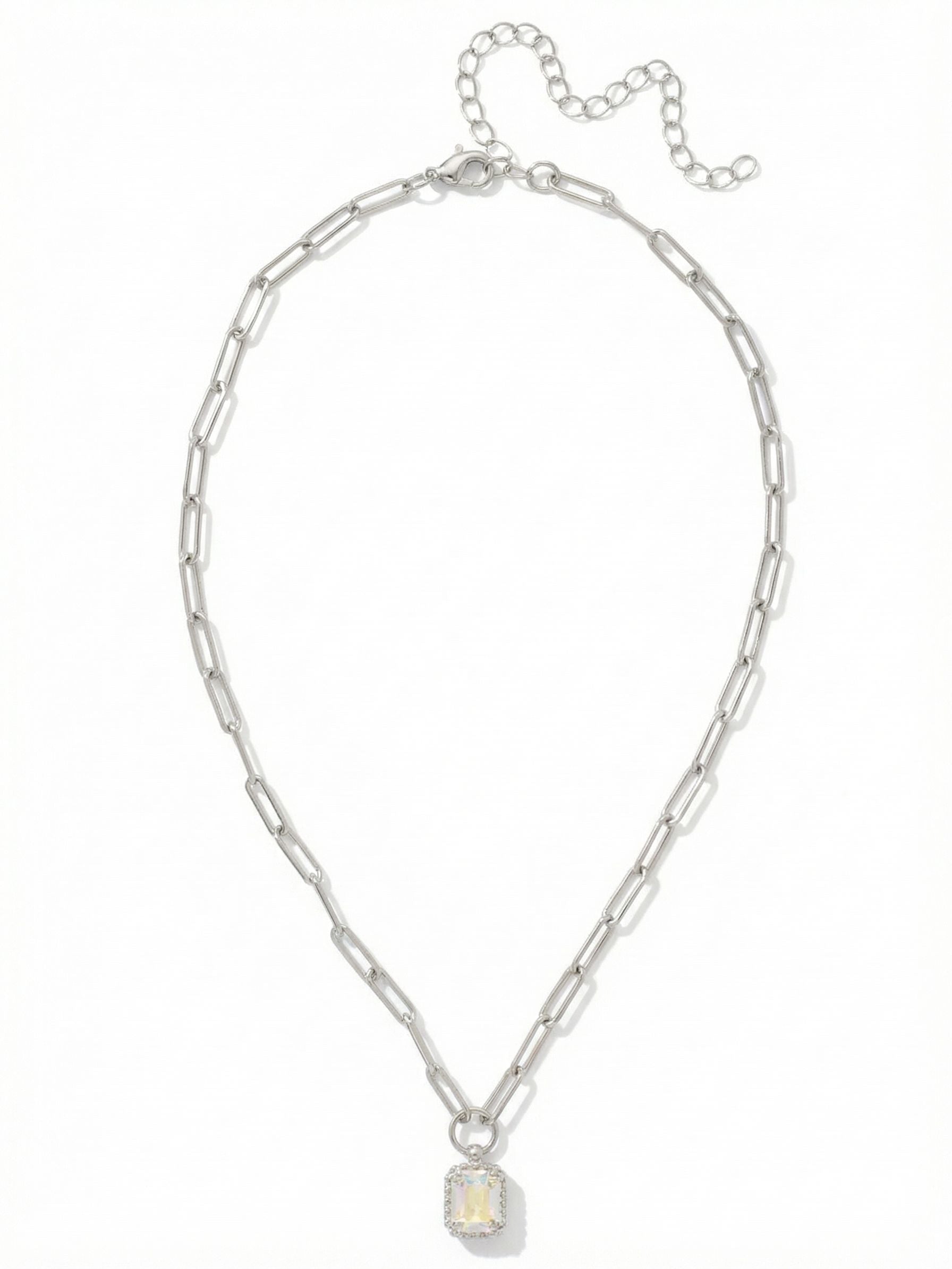 Octavia Scalloped Pendant Necklace - NGA1PDCAB - <p>A solitary emerald-cut crystal anchors this piece. Its iridescent surface shifts softly as it catches the light. The pendant is framed by a delicate scalloped edge, bringing subtle texture to the clean lines of the stone. It hangs from an airy paperclip chain that drapes easily across the collarbone. The elongated links feel modern and light, balancing the iridescent focal point. An adjustable extension chain lets you shift the length to layer seamlessly with your everyday necklaces.</p><ul>
<li>Solitary emerald-cut crystal framed by a textured scalloped setting</li>
<li>Airy paperclip chain with elongated oval links</li>
<li>Lobster claw clasp</li>
<li>4-inch adjustable extension chain</li>
<li>Protective e-coat finish for lasting wear</li>
<li>Includes signature organza pouch for gifting and travel</li>
</ul>