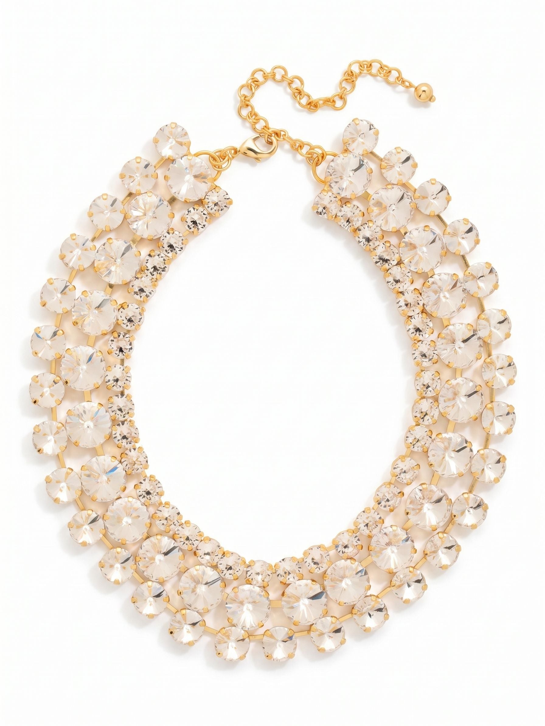 Penelope Layered Statement Necklace - NGB4BGCRY - <p>Three tiers of round clear crystals create a structured collar that surrounds the neckline with continuous light. A central row of prominent fourteen-millimeter stones anchors the design, framed by gently graduated cuts that build substantial visual impact without feeling heavy. The fixed kette construction holds each crystal precisely in place so the tiered shape maintains its form as you move. An integrated extension chain allows you to tailor the drape, letting you position the piece exactly where it suits your chosen neckline.</p><ul>
<li>Three tiered rows of round crystals form a structured collar silhouette</li>
<li>Fixed kette construction ensures the layered design holds its shape in motion</li>
<li>Lobster claw clasp</li>
<li>4-inch adjustable extension chain</li>
<li>Protective e-coat finish for lasting wear</li>
<li>Includes signature organza pouch for gifting and travel</li>
</ul>