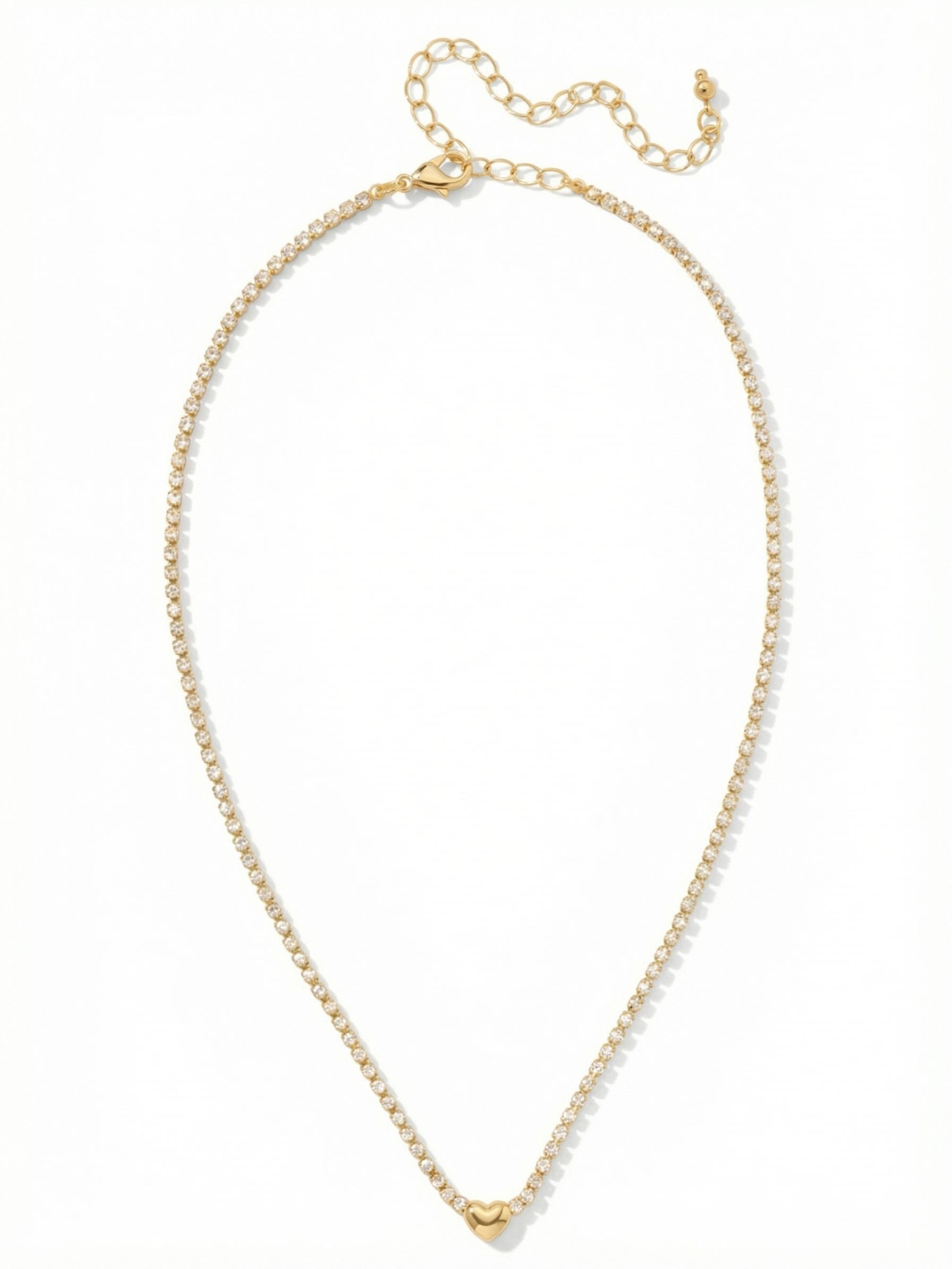 Mini Marnie Heart Tennis Necklace - NGF6BGCRY - <p>A single unbroken line of tiny crystals anchors a smooth metal heart right at the collarbone. The delicate rhinestone chain brings a quiet, continuous catch of light to your neckline. Thanks to the extension chain, you can adjust the drop to nest perfectly above a t-shirt or layer seamlessly with heavier pendants. It is a subtle, familiar shape rendered in bright metal and clear crystal for effortless daily wear.</p><ul>
<li>Slender continuous rhinestone chain offers subtle light</li>
<li>Center polished metal heart charm creates a clean focal point</li>
<li>Lobster claw clasp</li>
<li>4-inch adjustable extension chain</li>
<li>Protective e-coat finish for lasting wear</li>
<li>Includes signature organza pouch for gifting and travel</li>
</ul>