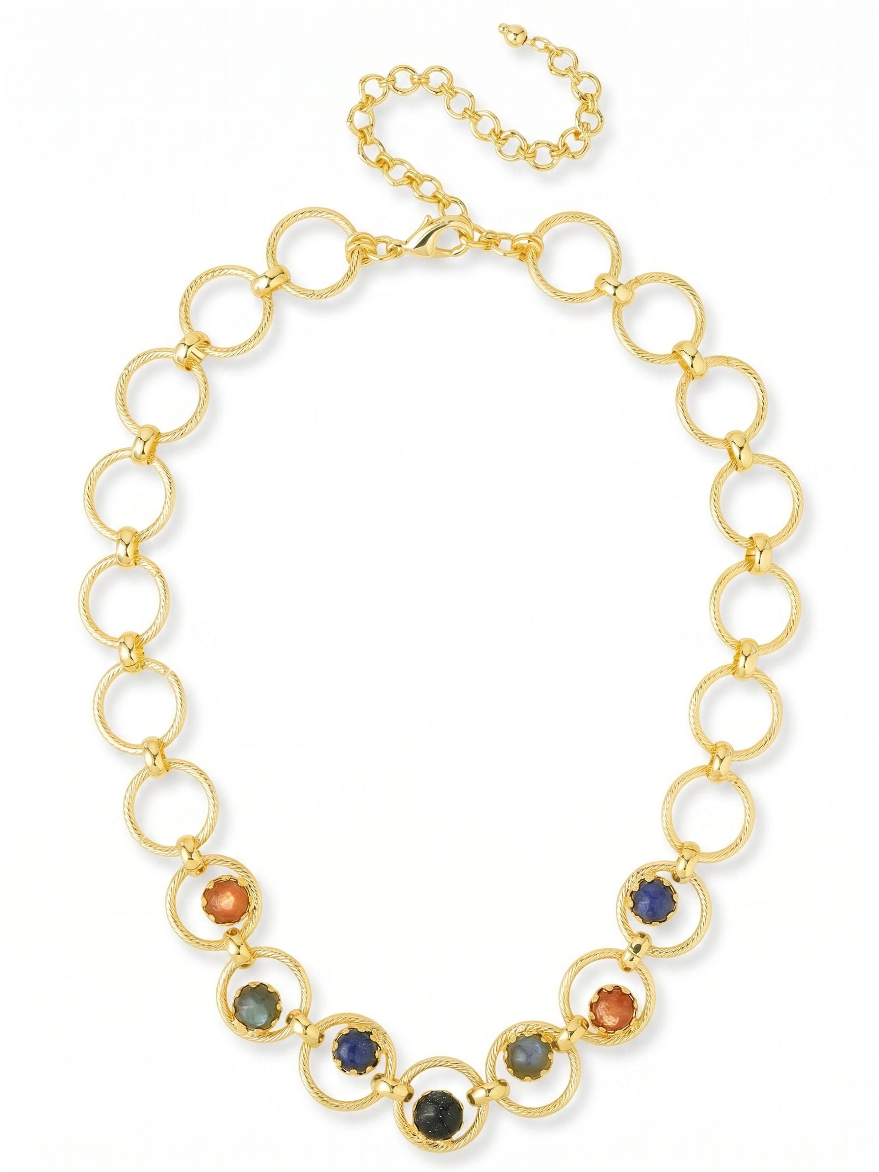 Odessa Tennis Necklace - NGI1BGDNM - <p>A series of textured gold rings create a bold but airy foundation that settles softly along the collarbone. The center links anchor a considered mix of round sodalite, warm sunstone, deep blue goldstone, and shifting labradorite. The open metalwork keeps the overall silhouette light, while the varied stones provide a grounded visual anchor. An included extension chain lets you adjust the drape, making it simple to position precisely over a structured collar or directly against the skin.</p><ul>
<li>Interlocking textured rings create an airy, substantial chain</li>
<li>Mixed semi-precious stones are suspended within the front circular links</li>
<li>Lobster claw clasp</li>
<li>4-inch adjustable extension chain</li>
<li>Protective e-coat finish for lasting wear</li>
<li>Includes signature organza pouch for gifting and travel</li>
</ul>