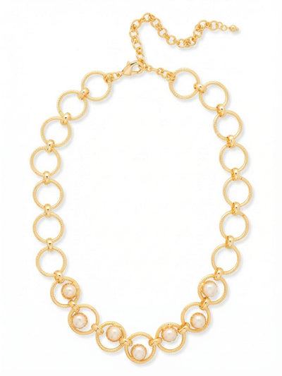 Odessa Tennis Necklace - NGI1BGMDP - <p>Open gold-tone circles link together to form a lightweight collar that drapes softly along the collarbone. At the center of the design, seven round white pearls are suspended within textured metal rings, creating a gentle floating effect as you move. The rope-like detailing on the interlocking links adds warmth and dimension against the smooth luster of the pearls. An adjustable chain lets you easily tailor the drop to suit your neckline or layer with other pieces.</p><ul>
<li>Floating pearls suspended inside textured circular links</li>
<li>Interlocking rings with a twisted rope motif</li>
<li>Lobster claw clasp</li>
<li>4-inch adjustable extension chain</li>
<li>Protective e-coat finish for lasting wear</li>
<li>Includes signature organza pouch for gifting and travel</li>
</ul>