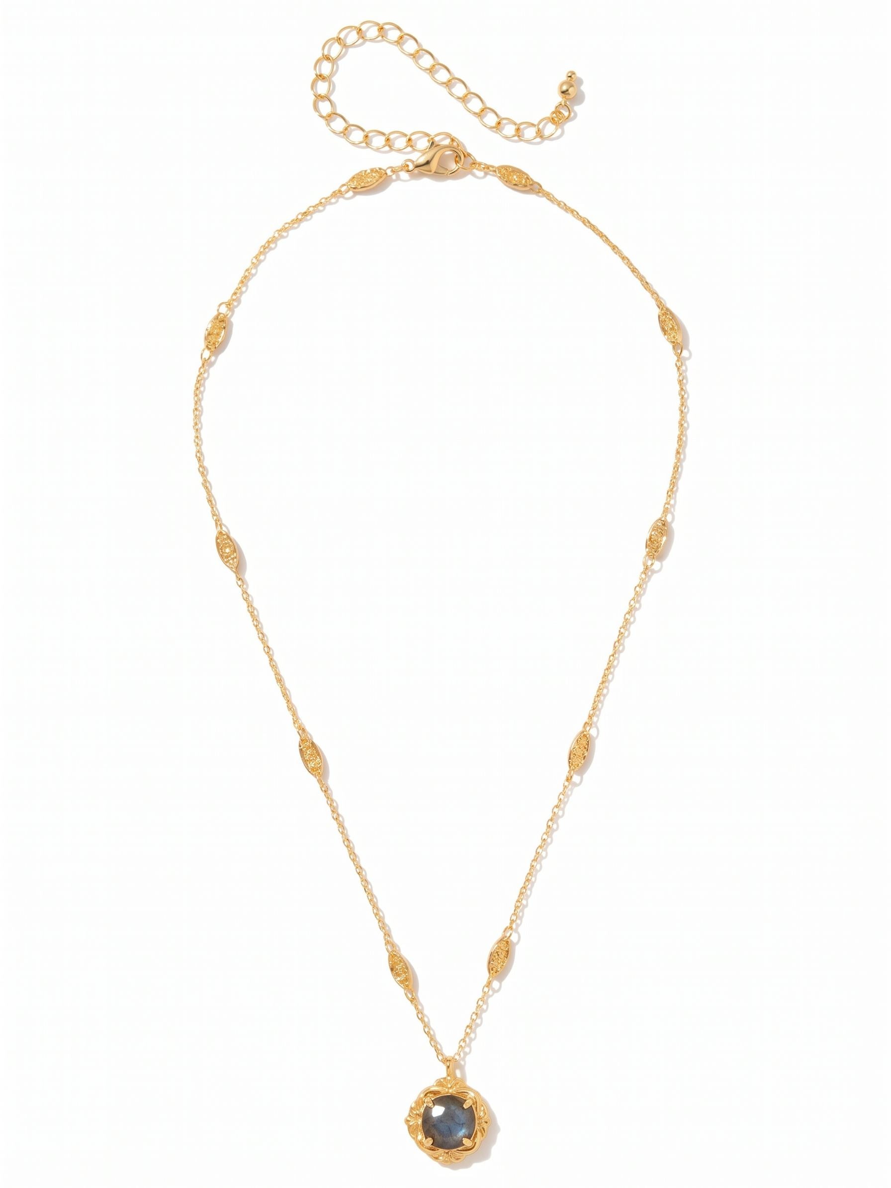 Lori Pendant Necklace - NGI2BGLAB - <p>A single round labradorite anchors this fine gold-tone chain, set within a highly textured, vintage-inspired bezel. Small textured stations along the length of the chain add a quiet visual rhythm as it rests near your collarbone. The natural flashes of color in the stone catch the light softly as you move. Built with a four-inch extension chain, it adjusts easily to layer with your other daily pieces or stand quietly on its own.</p><ul>
<li>Decorative textured stations spaced evenly along a fine chain</li>
<li>Ornate vintage-inspired setting frames a single round-cut stone</li>
<li>Lobster claw clasp</li>
<li>4-inch adjustable extension chain</li>
<li>Protective e-coat finish for lasting wear</li>
<li>Includes signature organza pouch for gifting and travel</li>
</ul>