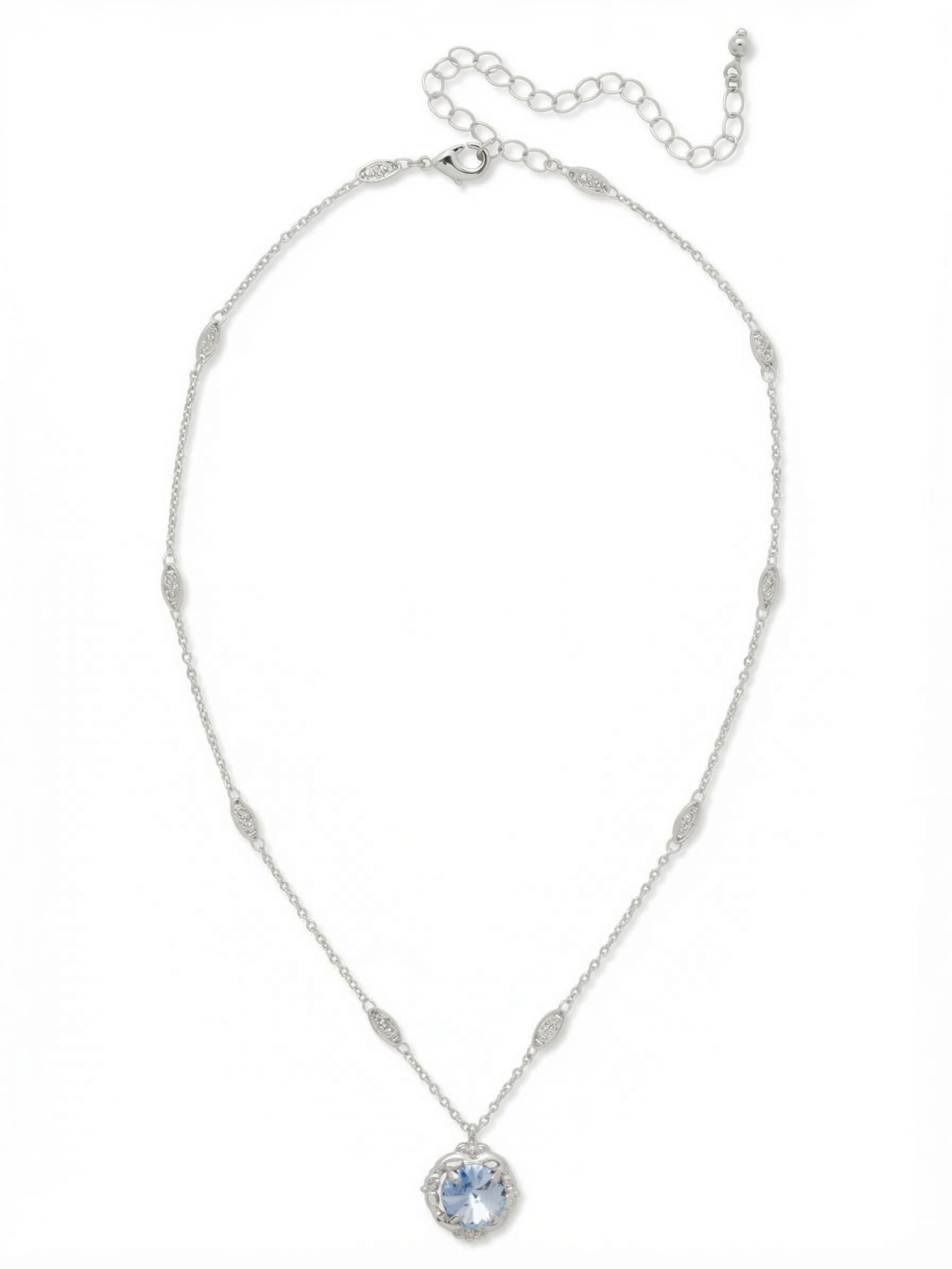 Lori Pendant Necklace - NGI2PDLTS - <p>A delicate approach to daily color. The Lori Pendant centers a solitary round-cut crystal in a scalloped palladium setting, catching the light with every subtle shift. Rather than a standard plain link, the pendant suspends from a fine chain detailed with spaced, textured metalwork stations that add quiet visual interest around the collarbone. An extension chain allows the drop to adapt to different necklines, making it a reliable foundation for layered looks or a focused singular detail.</p><ul>
<li>Fine chain detailed with textured metalwork stations</li>
<li>Solitary round-cut crystal secured in a scalloped setting</li>
<li>Lobster claw clasp</li>
<li>4-inch adjustable extension chain</li>
<li>Protective e-coat finish for lasting wear</li>
<li>Includes signature organza pouch for gifting and travel</li>
</ul>