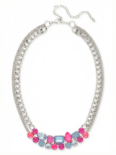 Moxie Tennis Necklace - NGI4PDPBZ - <p>Vibrant pink and soft blue crystals gather in a dense cluster at the collarbone, creating a deliberate focal point of mixed geometric cuts. This colorful arrangement is balanced by the substantial drape of a layered metal foundation combining a textured mesh chain with classic cable links. The asymmetrical stone placement gives the piece a distinct edge while remaining highly wearable. An included four-inch extension lets you adjust the length, ensuring the weighted center rests comfortably along your neckline.</p><ul>
<li>Concentrated asymmetrical cluster of multi-cut crystals</li>
<li>Substantial double-strand foundation combining mesh and cable chains</li>
<li>Lobster claw clasp</li>
<li>Protective e-coat finish for lasting wear</li>
<li>Includes signature organza pouch for gifting and travel</li>
</ul>