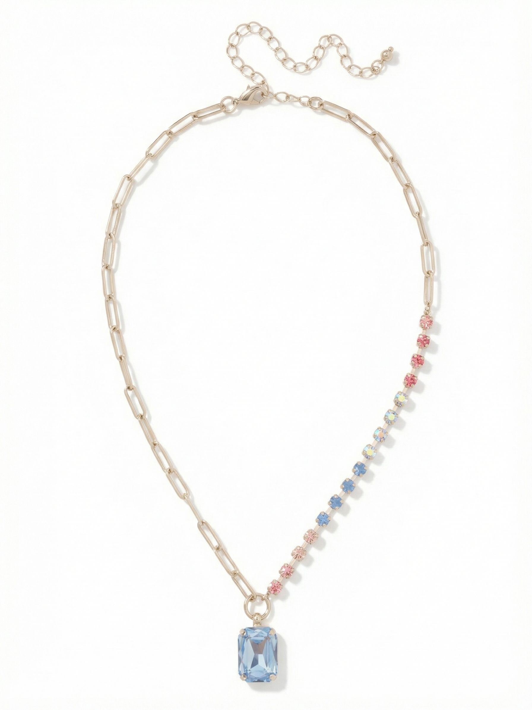 Iris Pendant Necklace - NGI5PDPBZ - <p>Half polished metal and half crystal light. This asymmetric pendant joins a clean paperclip chain with a delicate channel of soft rose and blue stones. At the center drops a substantial emerald-cut crystal that naturally anchors the lightweight framework above it. The mixed textures drape fluidly at the collarbone, bringing quiet visual interest to an open neckline while leaving plenty of room to layer. An extension chain lets you fine-tune the drop to match your exact collar.</p><ul>
<li>Asymmetric design mixing open paperclip links with a crystal-set channel</li>
<li>Large focal emerald-cut stone balanced by delicate round pastel accents</li>
<li>Lobster claw clasp</li>
<li>4-inch adjustable extension chain</li>
<li>Protective e-coat finish for lasting wear</li>
<li>Includes signature organza pouch for gifting and travel</li>
</ul>