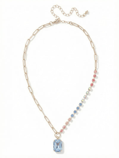 Iris Pendant Necklace - NGI5PDPBZ - <p>Half polished metal and half crystal light. This asymmetric pendant joins a clean paperclip chain with a delicate channel of soft rose and blue stones. At the center drops a substantial emerald-cut crystal that naturally anchors the lightweight framework above it. The mixed textures drape fluidly at the collarbone, bringing quiet visual interest to an open neckline while leaving plenty of room to layer. An extension chain lets you fine-tune the drop to match your exact collar.</p><ul>
<li>Asymmetric design mixing open paperclip links with a crystal-set channel</li>
<li>Large focal emerald-cut stone balanced by delicate round pastel accents</li>
<li>Lobster claw clasp</li>
<li>4-inch adjustable extension chain</li>
<li>Protective e-coat finish for lasting wear</li>
<li>Includes signature organza pouch for gifting and travel</li>
</ul>