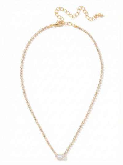 Mini Marnie Baguette Pendant Necklace - NGJ1BGCRY - <p>A slender line of tiny crystals traces the collarbone, anchoring a single rectangular step-cut stone at the center. The geometric cut of the focal crystal offers a clean flash of light that contrasts with the continuous shimmer of the delicate chain. Designed to sit high on the neckline, the built-in extension lets you adjust the drop to complement different collar shapes. It brings a quiet architecture to your daily layering rotation, providing just enough structure to stand apart.</p><ul>
<li>Horizontal rectangular step-cut focal crystal</li>
<li>Slender rhinestone chain for continuous light</li>
<li>Lobster claw clasp</li>
<li>4-inch adjustable extension chain</li>
<li>Protective e-coat finish for lasting wear</li>
<li>Includes signature organza pouch for gifting and travel</li>
</ul>