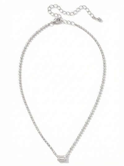 Mini Marnie Baguette Pendant Necklace - NGJ1PDCRY - <p>A fine thread of continuous light meets a structured geometric center. The Mini Marnie necklace anchors a delicate rhinestone chain with a single horizontal baguette crystal. This clean, linear focal point draws the eye while resting effortlessly near the collarbone. With the included extension chain, you can easily adjust the placement from a close fit to a slightly more relaxed drape. It brings a quiet, intentional presence to an open collar or a simple silk shirt.</p><ul>
<li>Single horizontally set baguette crystal creates a sharp geometric focal point</li>
<li>Continuous rhinestone base chain provides unbroken light around the neckline</li>
<li>Lobster claw clasp</li>
<li>4-inch adjustable extension chain</li>
<li>Protective e-coat finish for lasting wear</li>
<li>Includes signature organza pouch for gifting and travel</li>
</ul>