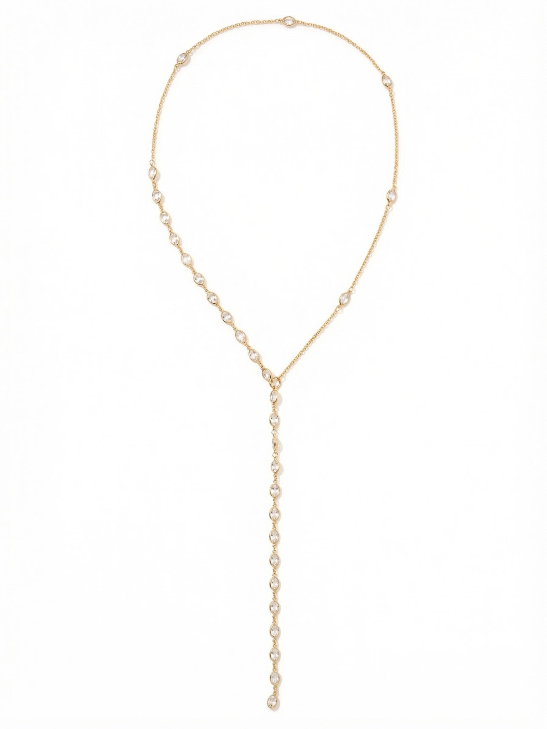 Rosalind Long Necklace - NGJ2BGCRY - <p>The Rosalind Long Necklace brings a delicate architectural feel to a classic lariat silhouette. A fine bright gold-tone cable chain meets an asymmetrical arrangement of bezel-set clear crystals, drawing the eye down to a central ring. From there, a continuous line of faceted crystals creates a fluid, weighted drop that sways naturally as you move. Designed without a clasp, this piece slips on easily, offering an unbroken line that elongates the frame and layers beautifully over higher necklines or deep plunging silhouettes alike.</p><ul>
<li>Asymmetrical crystal placement along a fine cable chain</li>
<li>Fluid lariat drop composed of continuous bezel-set crystals</li>
<li>Adjustable length</li>
<li>Protective e-coat finish for lasting wear</li>
<li>Includes signature organza pouch for gifting and travel</li>
</ul>