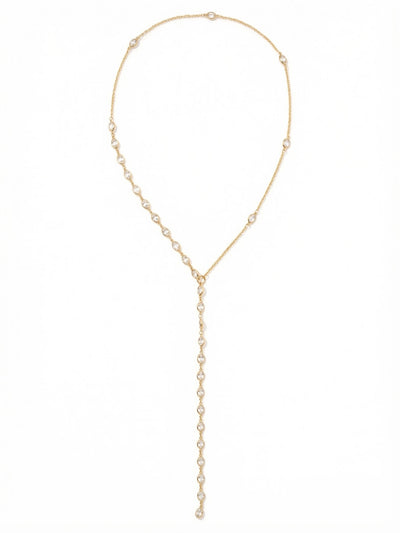 Rosalind Long Necklace - NGJ2BGCRY - <p>The Rosalind Long Necklace brings a delicate architectural feel to a classic lariat silhouette. A fine bright gold-tone cable chain meets an asymmetrical arrangement of bezel-set clear crystals, drawing the eye down to a central ring. From there, a continuous line of faceted crystals creates a fluid, weighted drop that sways naturally as you move. Designed without a clasp, this piece slips on easily, offering an unbroken line that elongates the frame and layers beautifully over higher necklines or deep plunging silhouettes alike.</p><ul>
<li>Asymmetrical crystal placement along a fine cable chain</li>
<li>Fluid lariat drop composed of continuous bezel-set crystals</li>
<li>Adjustable length</li>
<li>Protective e-coat finish for lasting wear</li>
<li>Includes signature organza pouch for gifting and travel</li>
</ul>