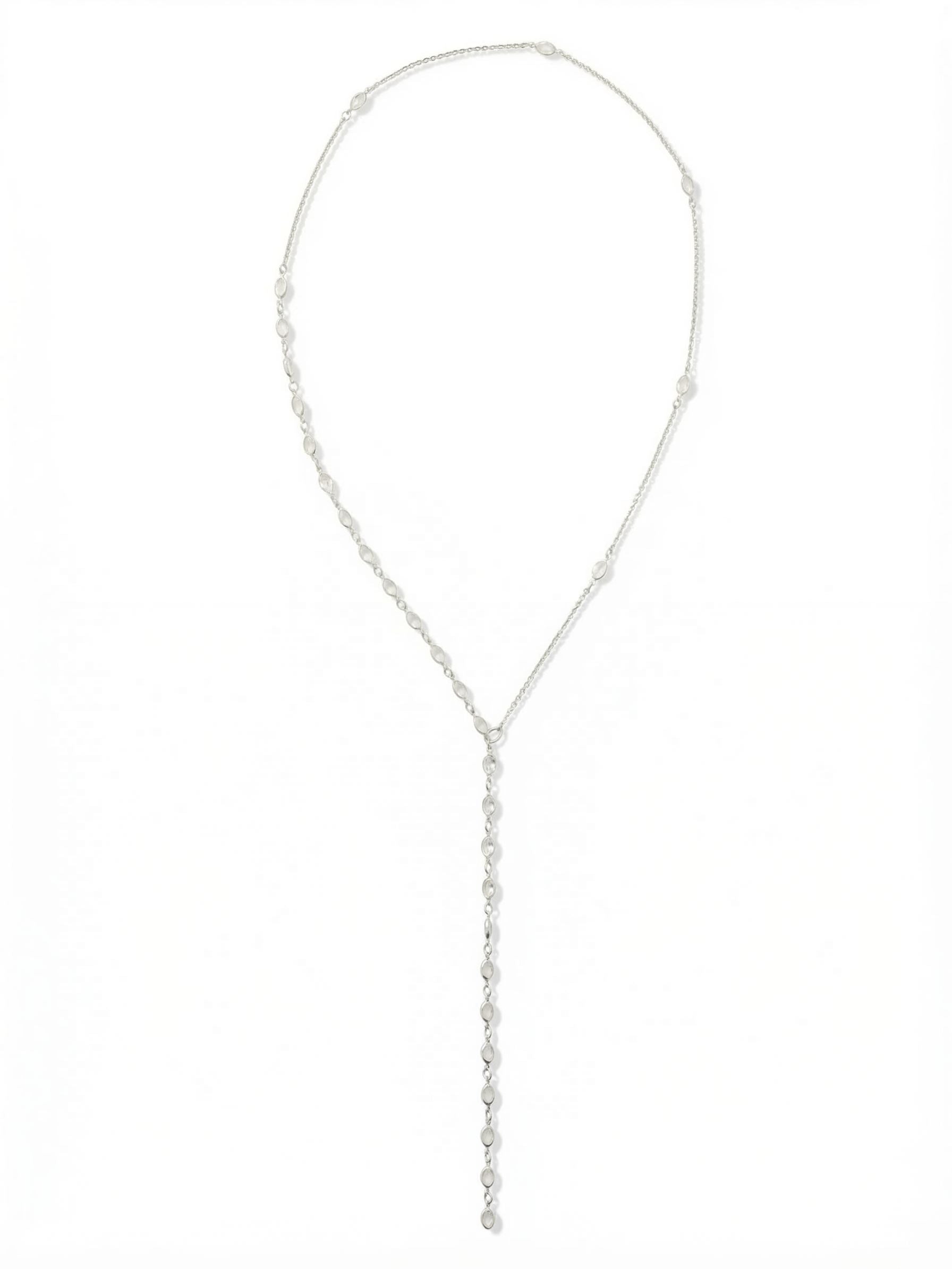 Rosalind Long Necklace - NGJ2PDCRY - <p>This twenty-eight-inch necklace brings an elegant verticality to your wardrobe. Crafted with a fine cable chain punctuated by individual crystals, the asymmetrical design converges into a fluid, linear drop that draws the eye downward. Designed without a clasp, it slips effortlessly over your head, offering instant polish on rushed mornings. The continuous line of clear stones catches ambient light with your every movement. It brings a quiet, elongated proportion that pairs just as easily with a structured blazer as a simple silk blouse.</p><ul>
<li>Fine cable chain punctuated by evenly spaced solitary crystals</li>
<li>Elongated Y-drop silhouette creates a sleek vertical line</li>
<li>Adjustable length</li>
<li>Protective e-coat finish for lasting wear</li>
<li>Includes signature organza pouch for gifting and travel</li>
</ul>