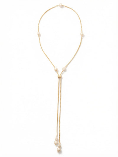 Winnie Long Necklace - NGJ3BGCRY - <p>A fluid box chain anchors this lariat design, draping cleanly down the chest to create a gently elongated silhouette. Stationed white and baroque pearls add soft luminescence along the gleaming metal. The sliding clasp allows you to easily adjust the central drop length, tailoring the proportion to suit a high collar or an open neckline. Weighted perfectly by the bottom pearls, the parallel chains maintain a steady, satisfying rhythm as you walk.</p><ul>
<li>Stationed white and baroque pearls spaced evenly along a fluid box chain</li>
<li>Weighted pearl ends keep the parallel twin drops draped cleanly in motion</li>
<li>Adjustable slider closure</li>
<li>Protective e-coat finish for lasting wear</li>
<li>Includes signature organza pouch for gifting and travel</li>
</ul>
