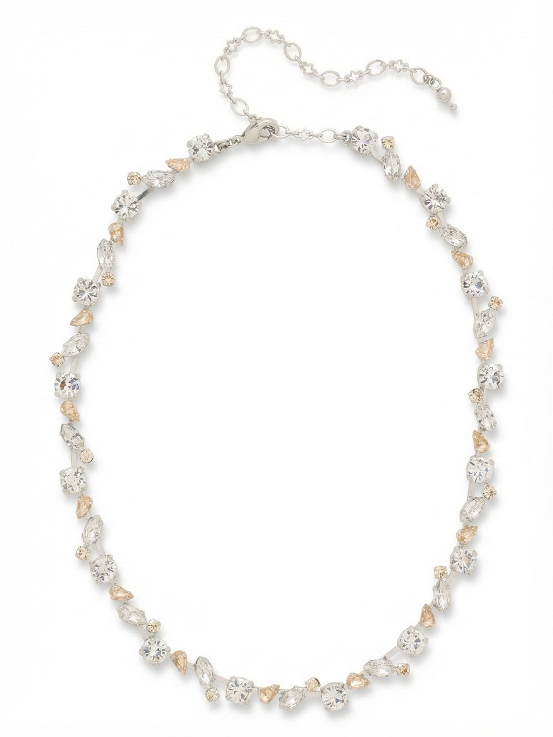 Daphne Tennis Necklace - NGJ5PDCLA - <p>This tennis necklace takes a softer approach to the classic linear style. Rather than a uniform row of identical stones, the design places round, marquise, and pear-cut crystals in a subtly staggered pattern along a flexible channel chain. Clear crystals catch the light alongside hints of warm silk and white opal, giving the piece a delicate texture. The articulated chain allows the necklace to drape naturally around the collarbone, moving easily as you do. A built-in four-inch extension chain provides an adjustable fit depending on your neckline.</p><ul>
<li>Subtly staggered arrangement of marquise, pear, and round crystal cuts</li>
<li>Articulated channel chain allows the necklace to drape fluidly</li>
<li>Lobster claw clasp</li>
<li>Protective e-coat finish for lasting wear</li>
<li>Includes signature organza pouch for gifting and travel</li>
</ul>