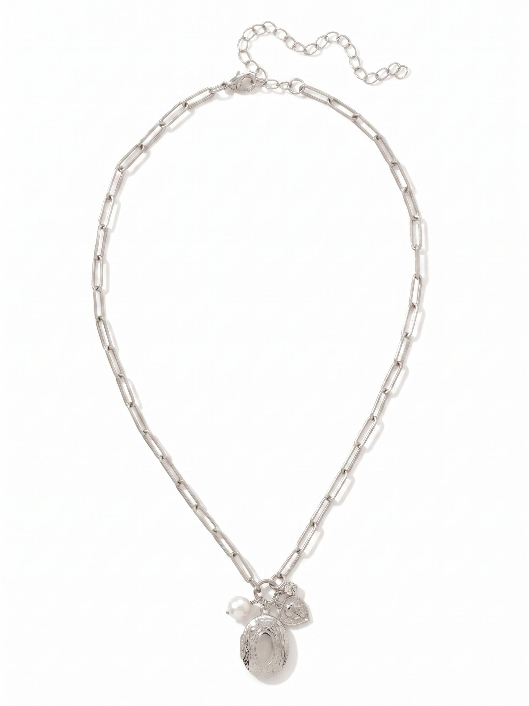 Rosie Locket Pendant Necklace - NGK1PDCRY - <p>Balancing the clean geometry of an open paperclip chain with the personal feel of gathered talismans, this necklace settles easily near the collarbone. A subtle cluster pairs an etched oval locket and a luminous freshwater pearl with a single round-cut crystal, creating quiet movement throughout your day. The airy links drape comfortably, while the four-inch extension lets you fine-tune the drop. It brings a tactile presence to your daily rotation, stepping in naturally as a standalone signature or layered favorite.</p><ul>
<li>Elongated paperclip links create an airy and effortless drape</li>
<li>Clustered focal point pairs an etched locket with a luminous baroque pearl</li>
<li>Lobster claw clasp</li>
<li>4-inch adjustable extension chain</li>
<li>Protective e-coat finish for lasting wear</li>
<li>Includes signature organza pouch for gifting and travel</li>
</ul>